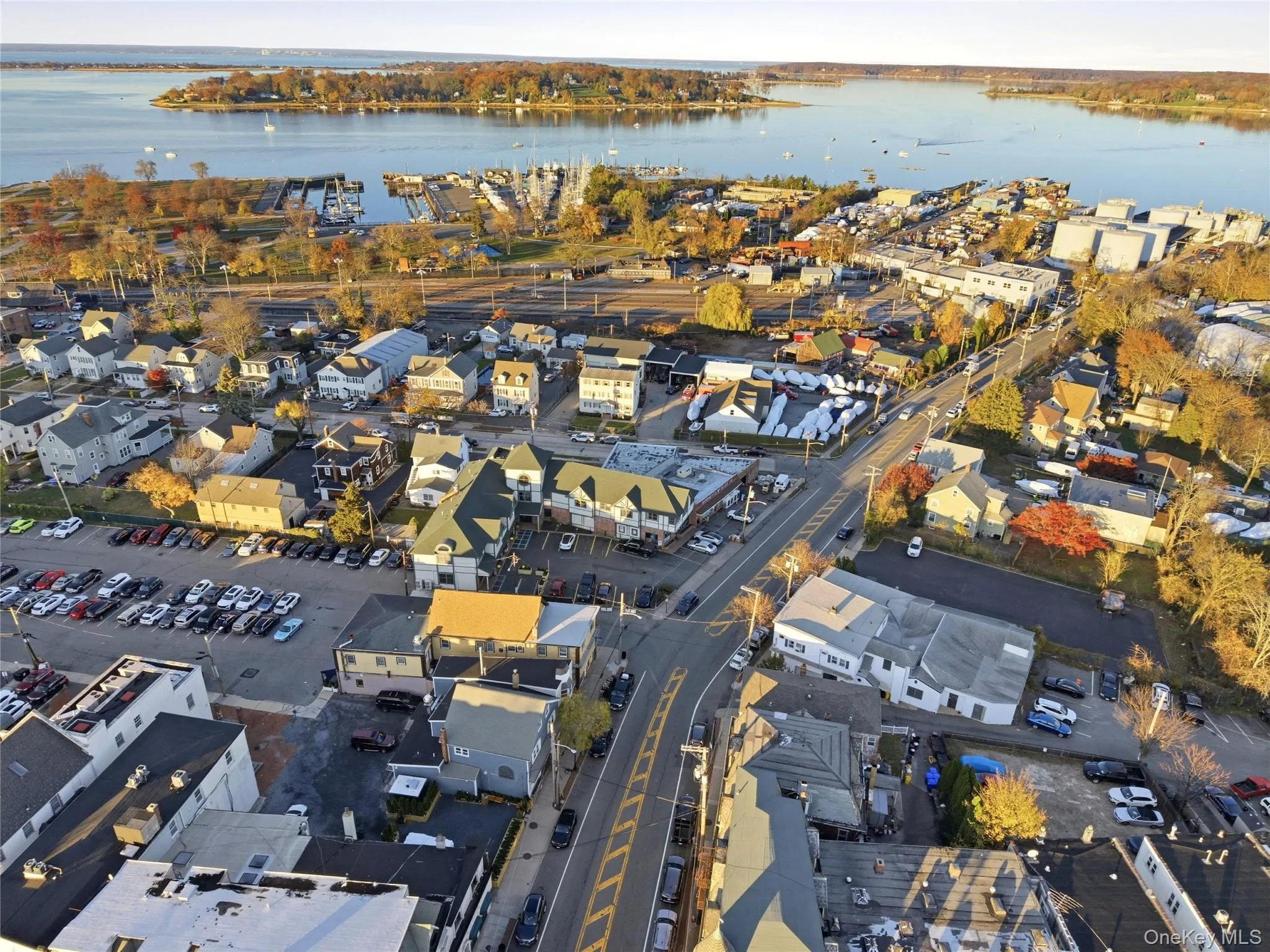 Aerial overview of property's location featuring nearby suburban area and a nearby body of water Aerial overview of property's location featuring nearby suburban area and a nearby body of water
