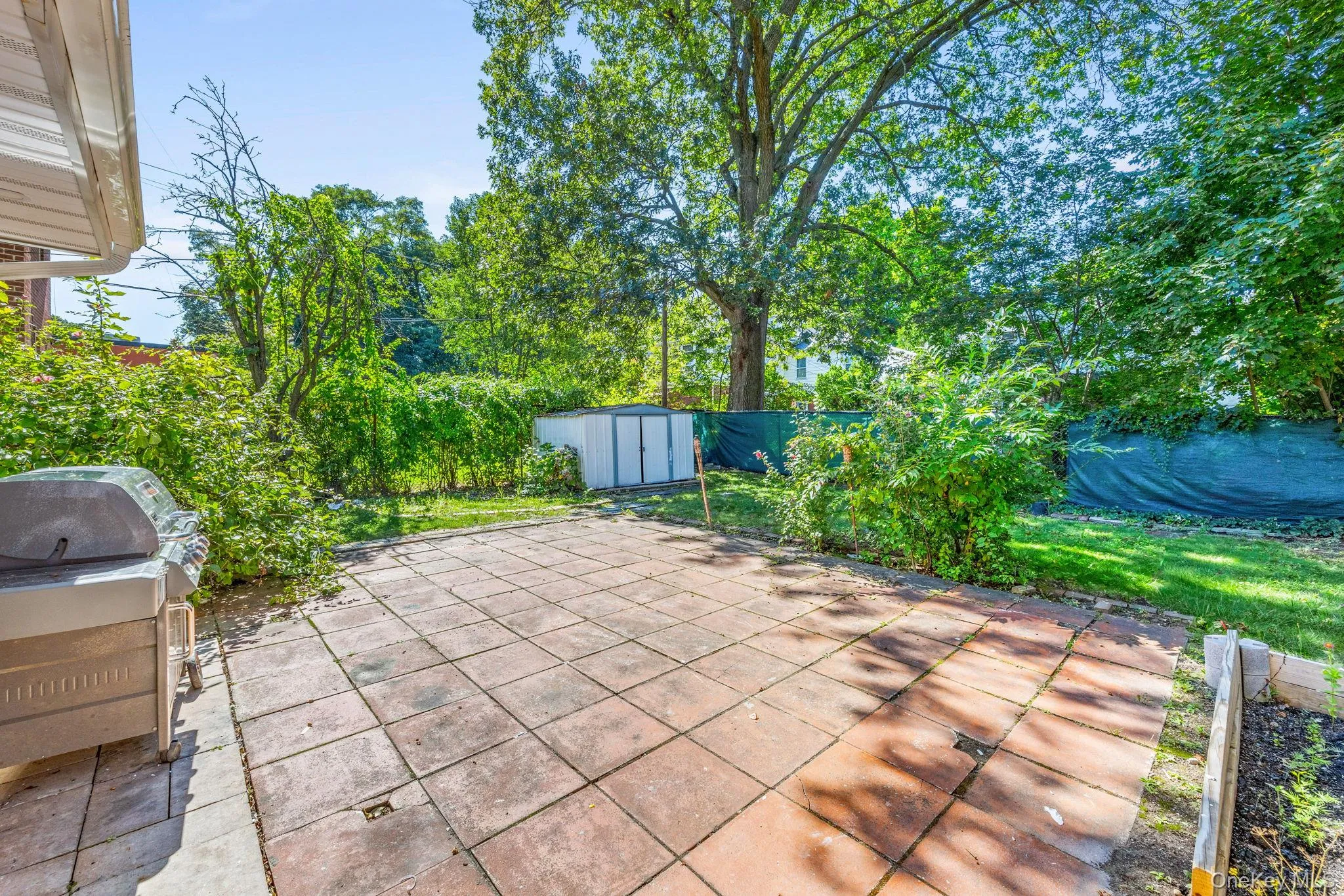 View of patio / terrace featuring a storage unit and grilling area View of patio / terrace featuring a storage unit and grilling area