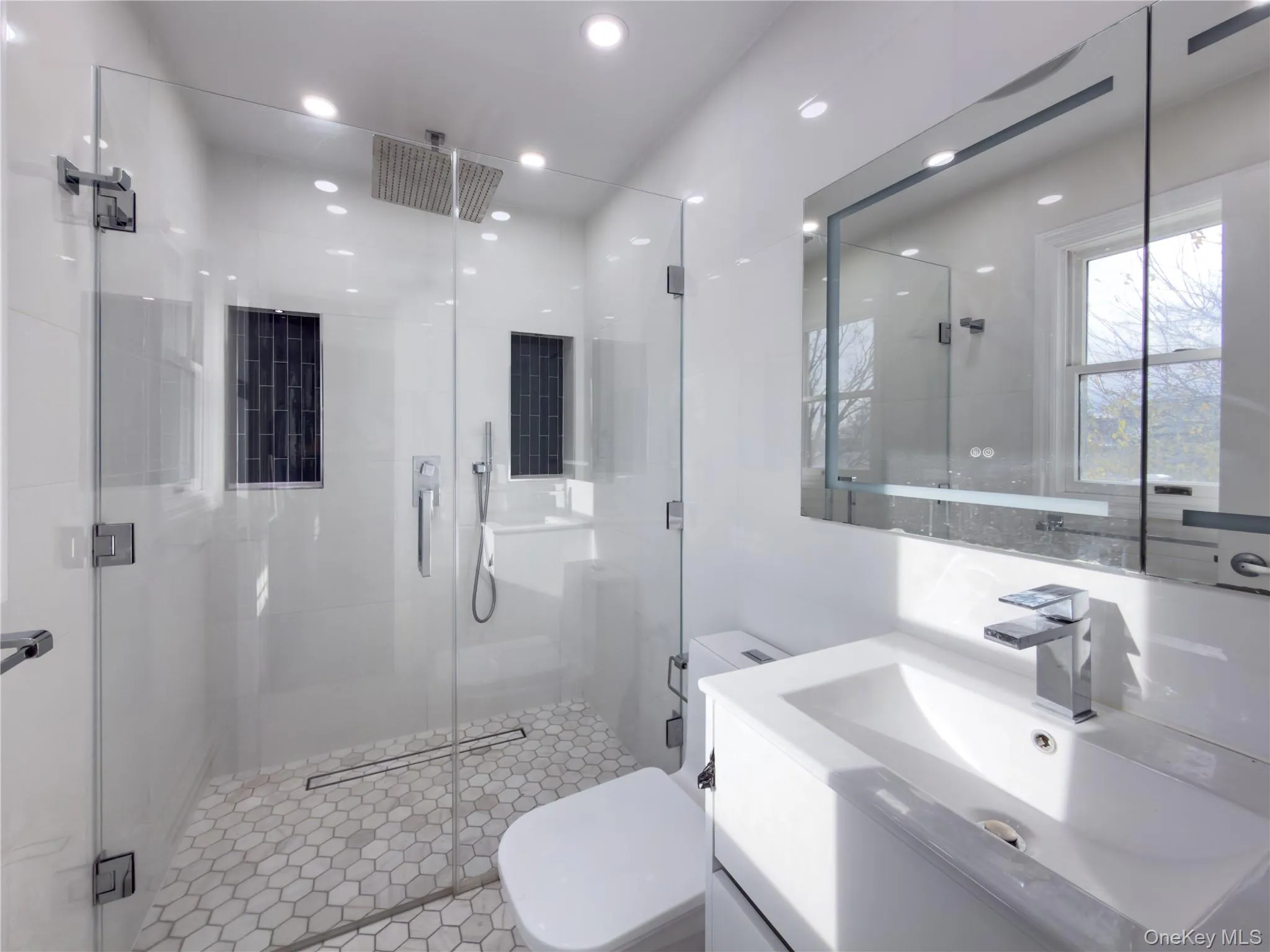 Bathroom featuring vanity, a shower stall, and recessed lighting Bathroom featuring vanity, a shower stall, and recessed lighting