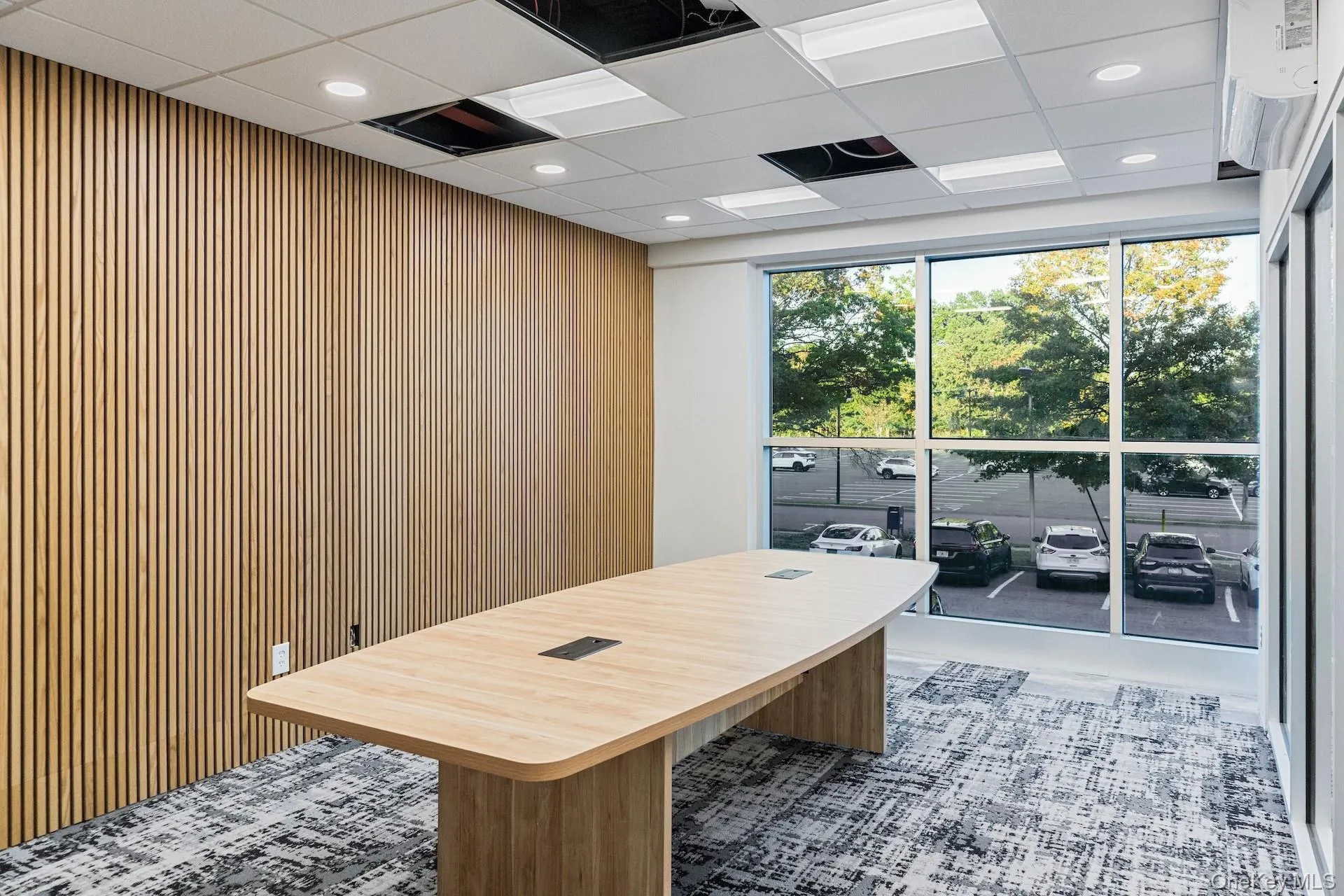Office area featuring a drop ceiling, recessed lighting, and wood walls Office area featuring a drop ceiling, recessed lighting, and wood walls
