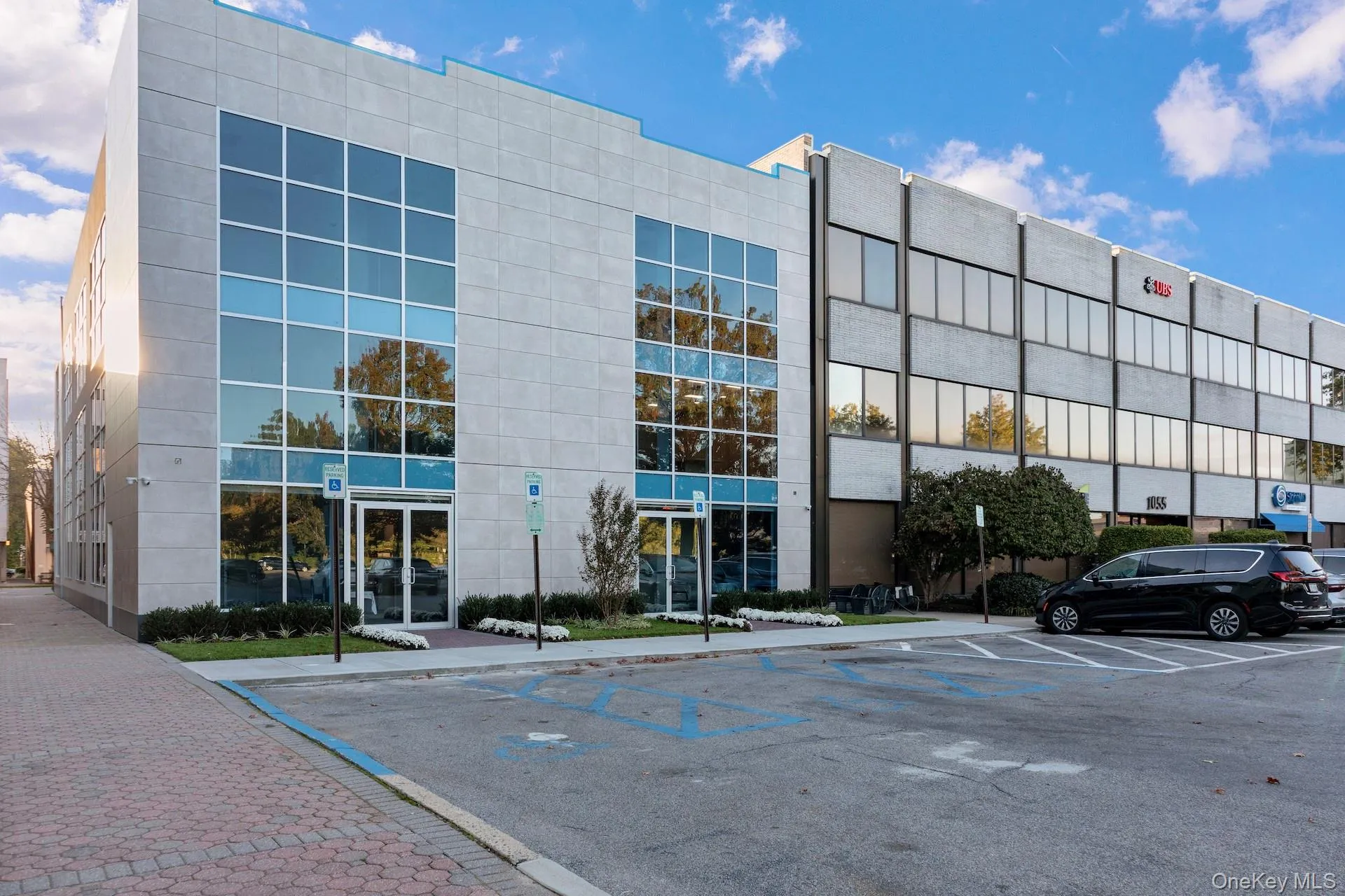 View of building exterior featuring uncovered parking View of building exterior featuring uncovered parking