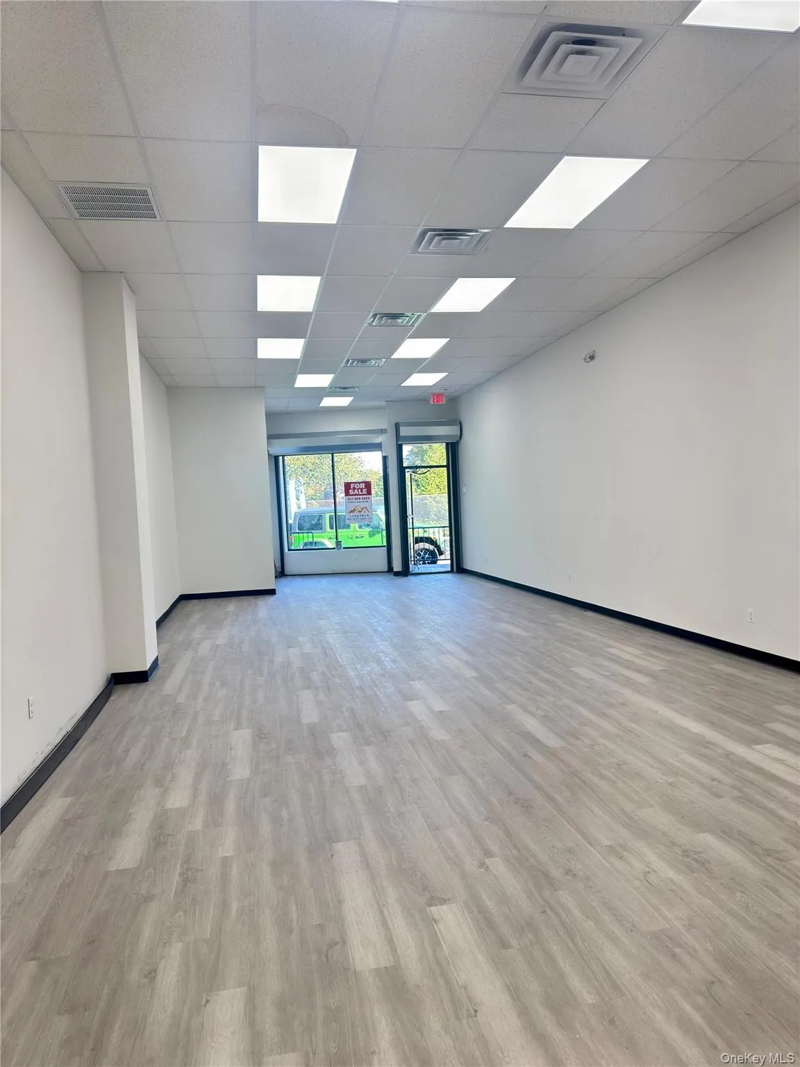 Spare room with light wood-type flooring and a drop ceiling Spare room with light wood-type flooring and a drop ceiling