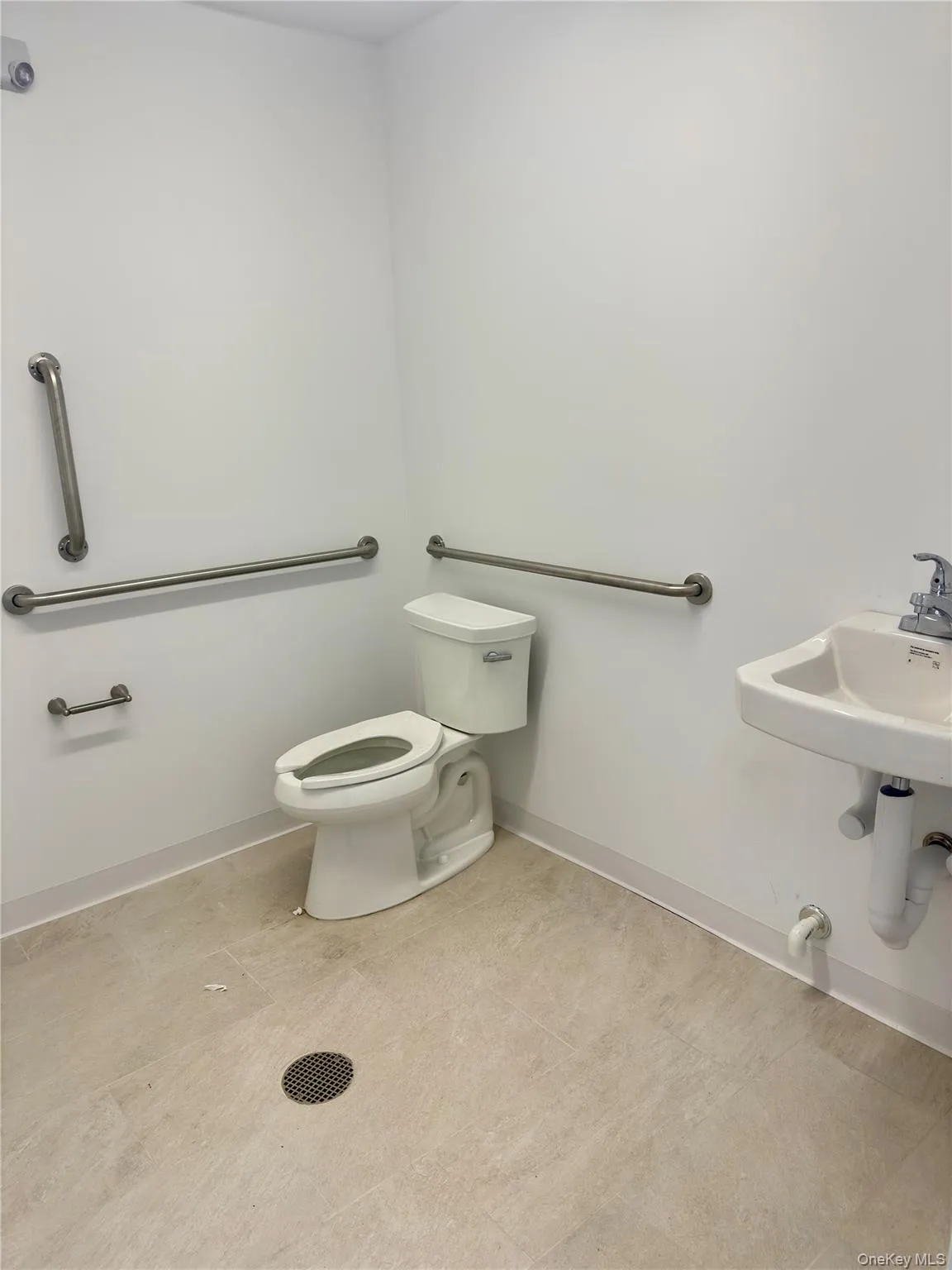 Bathroom featuring toilet and baseboards Bathroom featuring toilet and baseboards