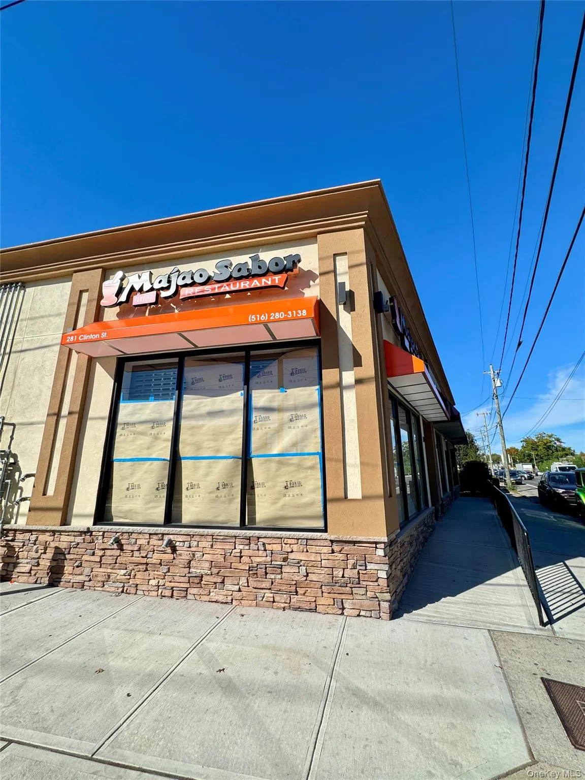 View of side of property featuring stucco siding and stone siding View of side of property featuring stucco siding and stone siding