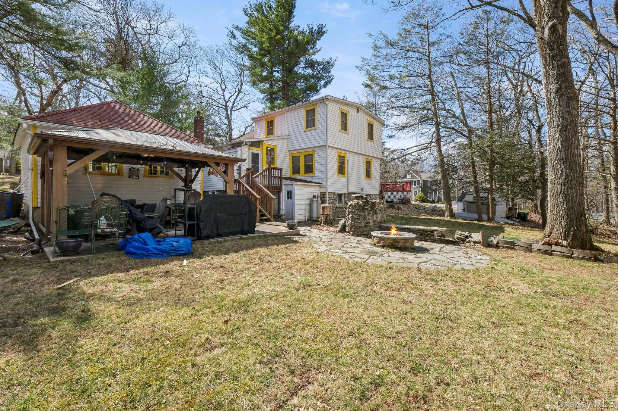 Back of property with a patio, a gazebo, an outdoor fire pit, a yard, and a storage unit Back of property with a patio, a gazebo, an outdoor fire pit, a yard, and a storage unit