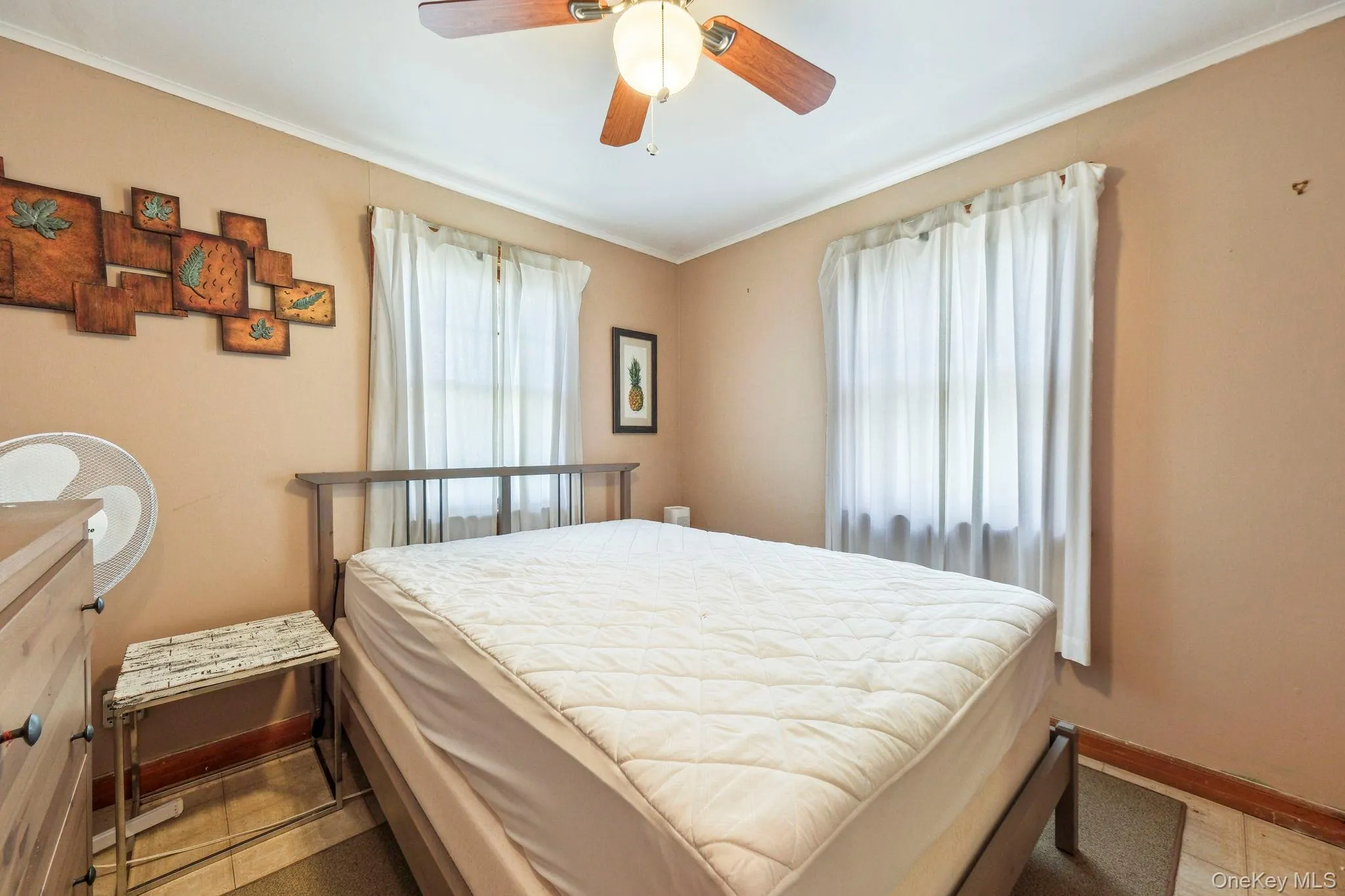 Bedroom featuring ceiling fan and crown molding Bedroom featuring ceiling fan and crown molding