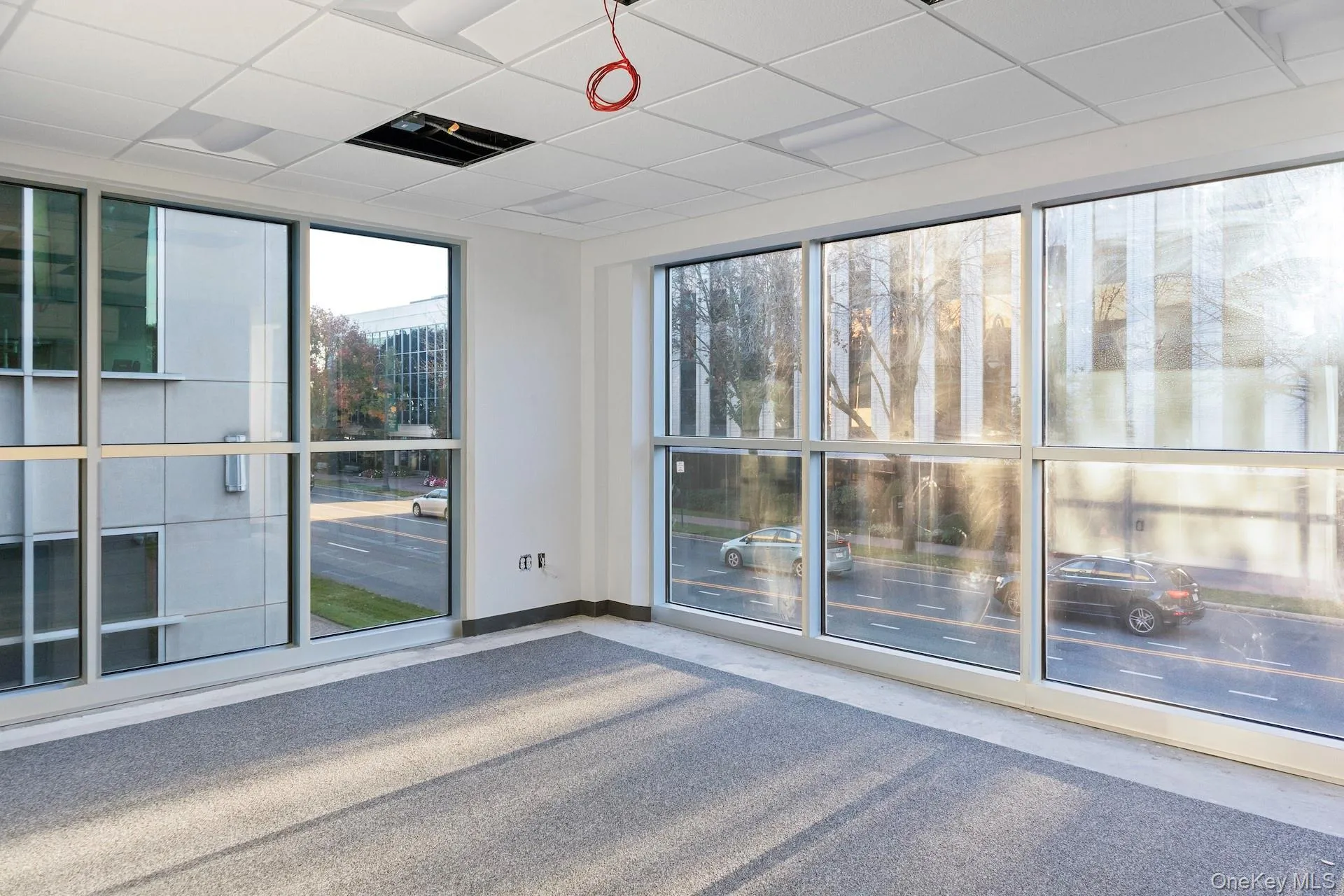 Unfurnished room featuring a drop ceiling and baseboards Unfurnished room featuring a drop ceiling and baseboards