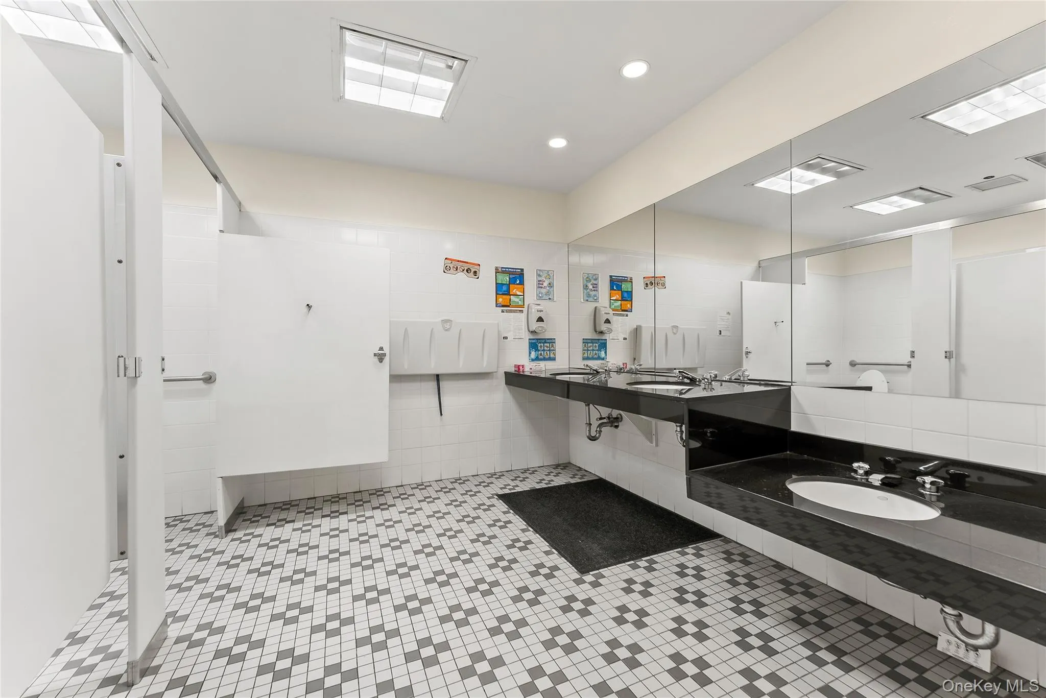 Full bathroom with vanity, tiled shower, recessed lighting, and tile walls Full bathroom with vanity, tiled shower, recessed lighting, and tile walls