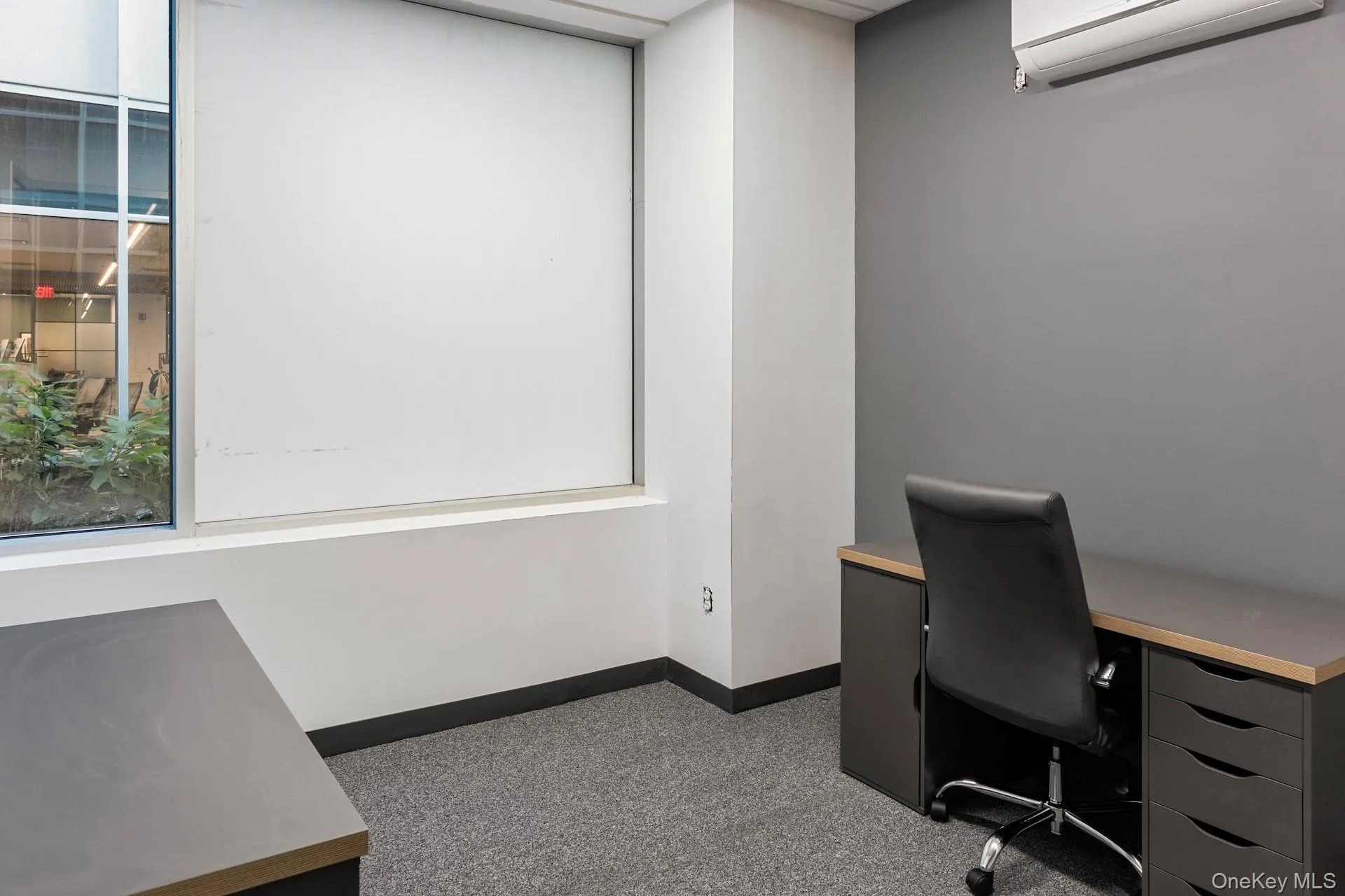 Office area with an AC wall unit Office area with an AC wall unit