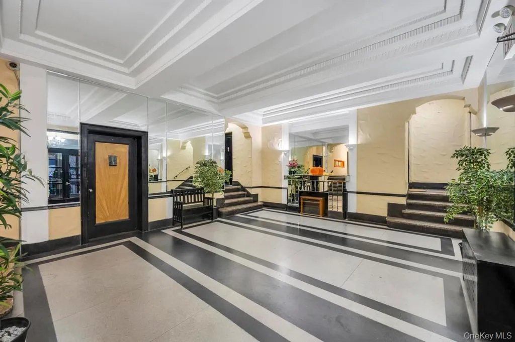 Community lobby featuring stairway and crown molding Community lobby featuring stairway and crown molding