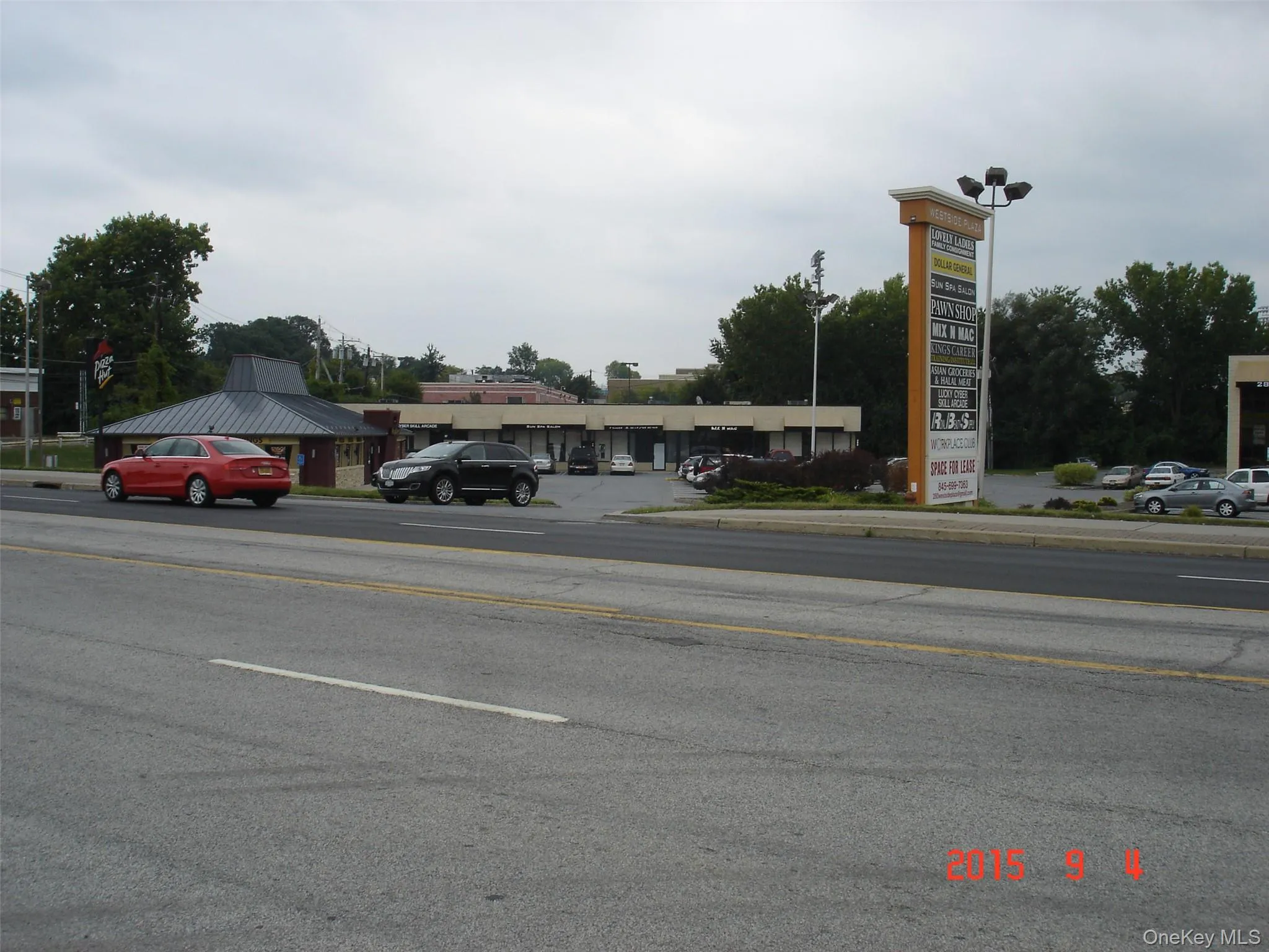 View of asphalt road with curbs and sidewalks View of asphalt road with curbs and sidewalks