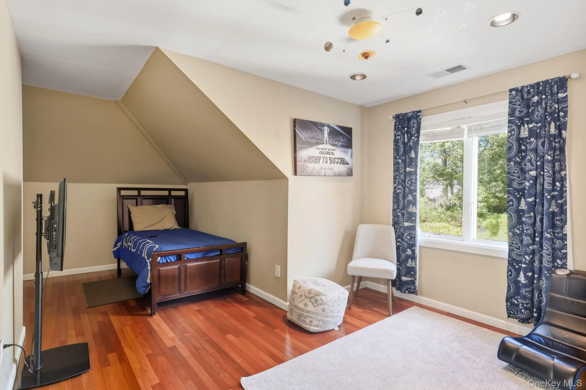 Bedroom with wood finished floors, vaulted ceiling, and recessed lighting Bedroom with wood finished floors, vaulted ceiling, and recessed lighting