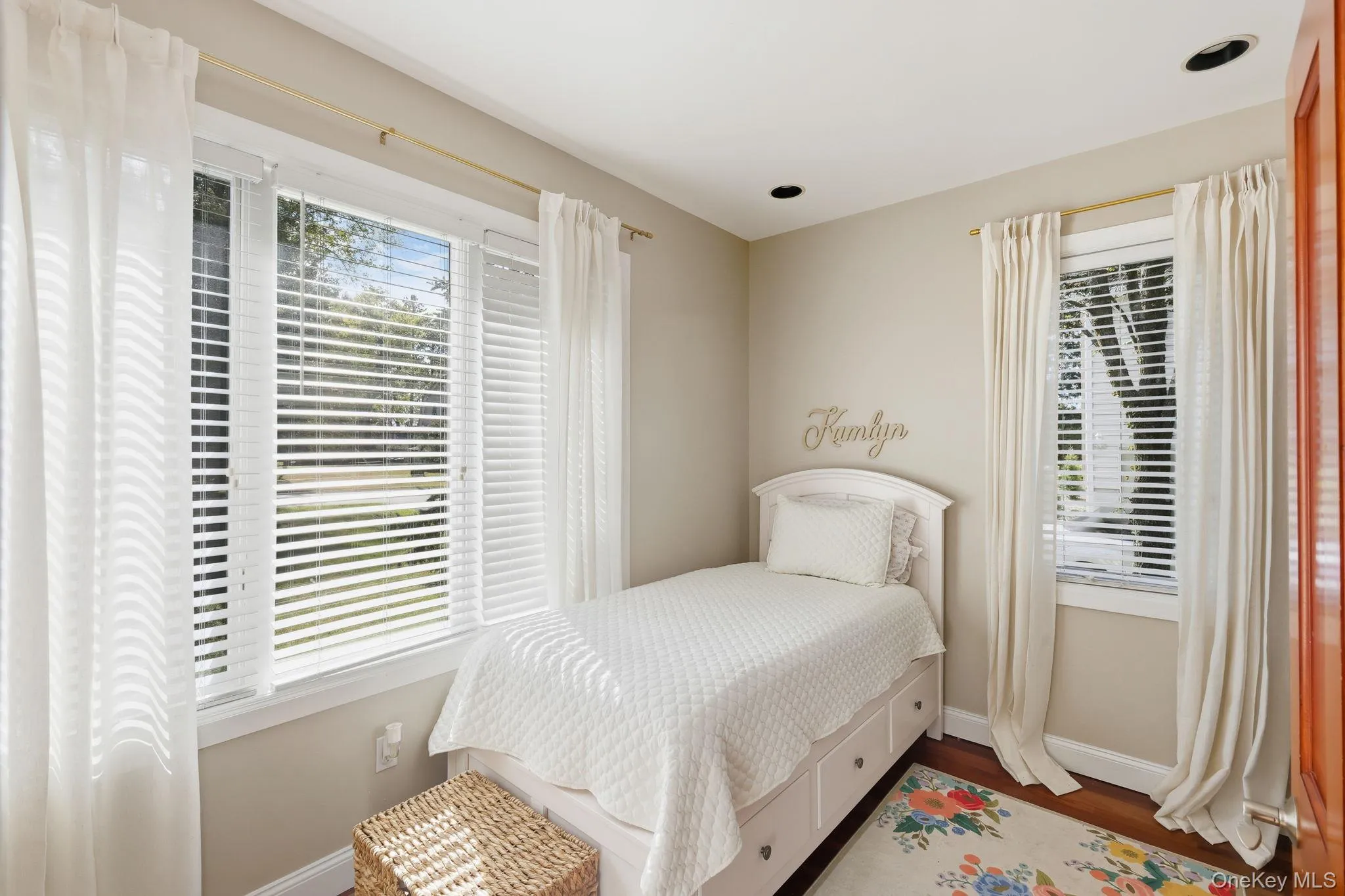 Bedroom featuring baseboards and wood finished floors Bedroom featuring baseboards and wood finished floors