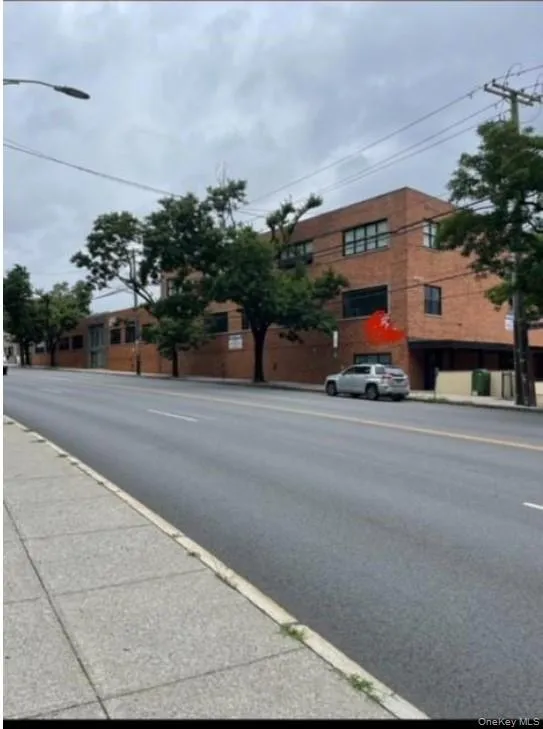 View of asphalt road with sidewalks, street lighting, and curbs View of asphalt road with sidewalks, street lighting, and curbs