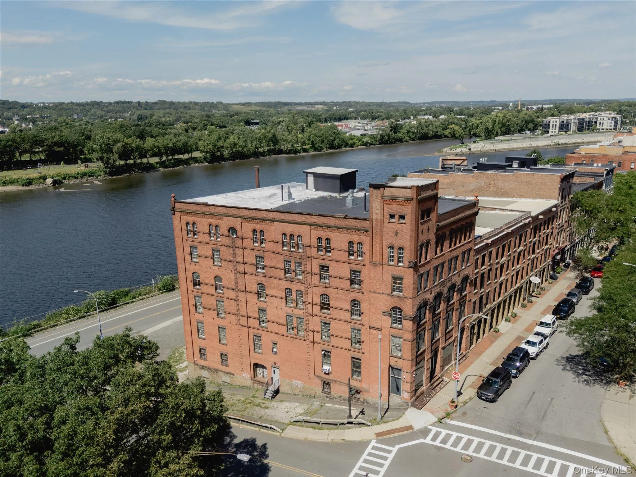 Aerial view of apartment complex / building and a large body of water Aerial view of apartment complex / building and a large body of water