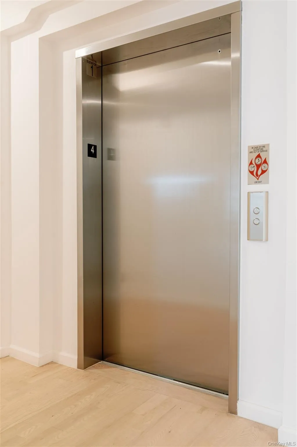 Elevator featuring wood finished floors and baseboards Elevator featuring wood finished floors and baseboards