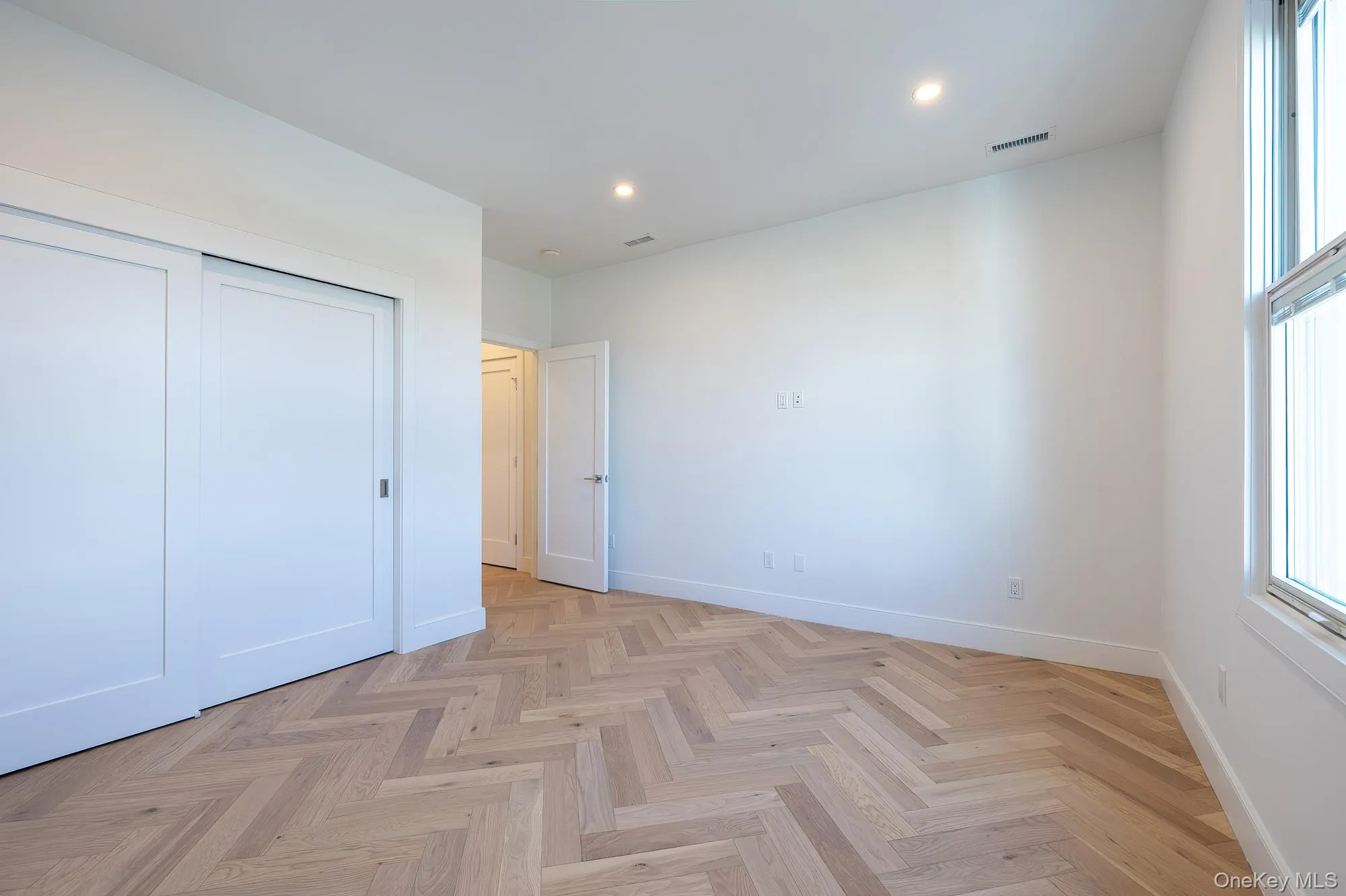 Unfurnished bedroom with recessed lighting and a closet Unfurnished bedroom with recessed lighting and a closet