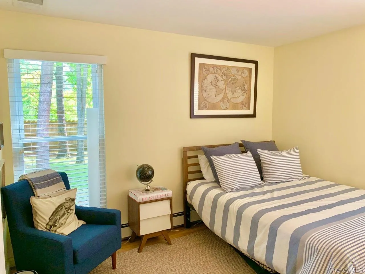 Bedroom with wood finished floors and a baseboard radiator Bedroom with wood finished floors and a baseboard radiator
