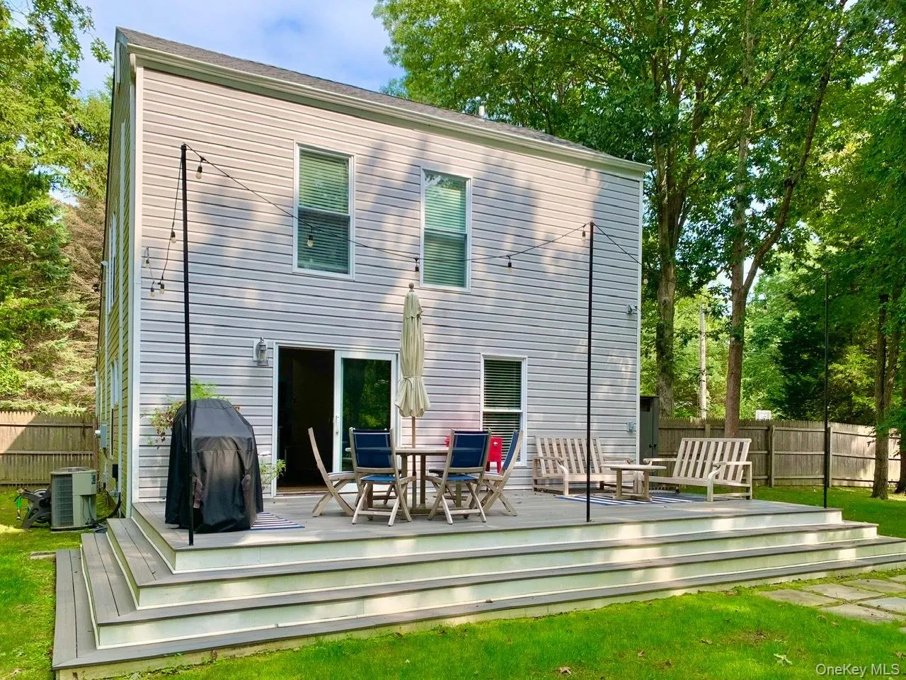 Back of property featuring a wooden deck and outdoor dining area Back of property featuring a wooden deck and outdoor dining area