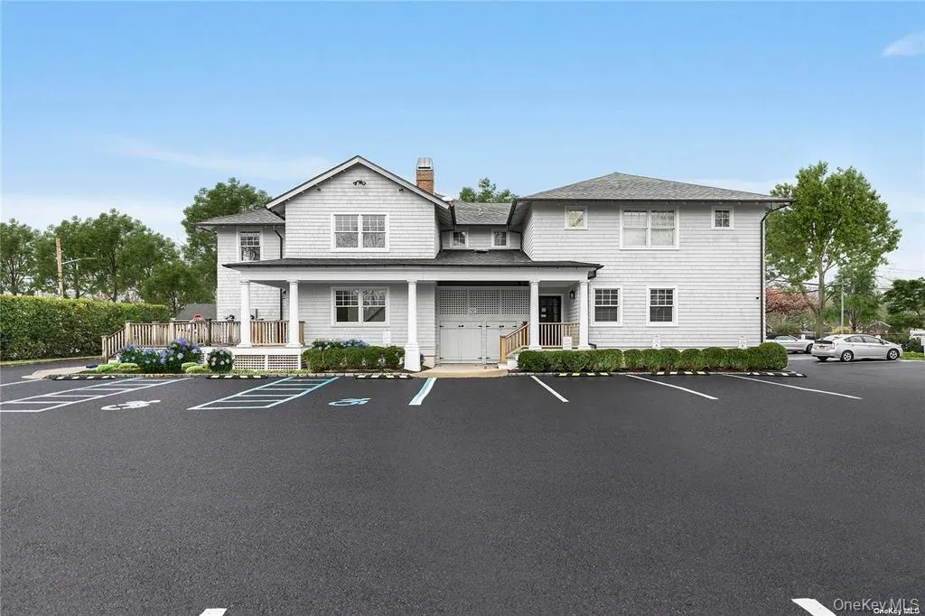 View of building exterior featuring uncovered parking View of building exterior featuring uncovered parking