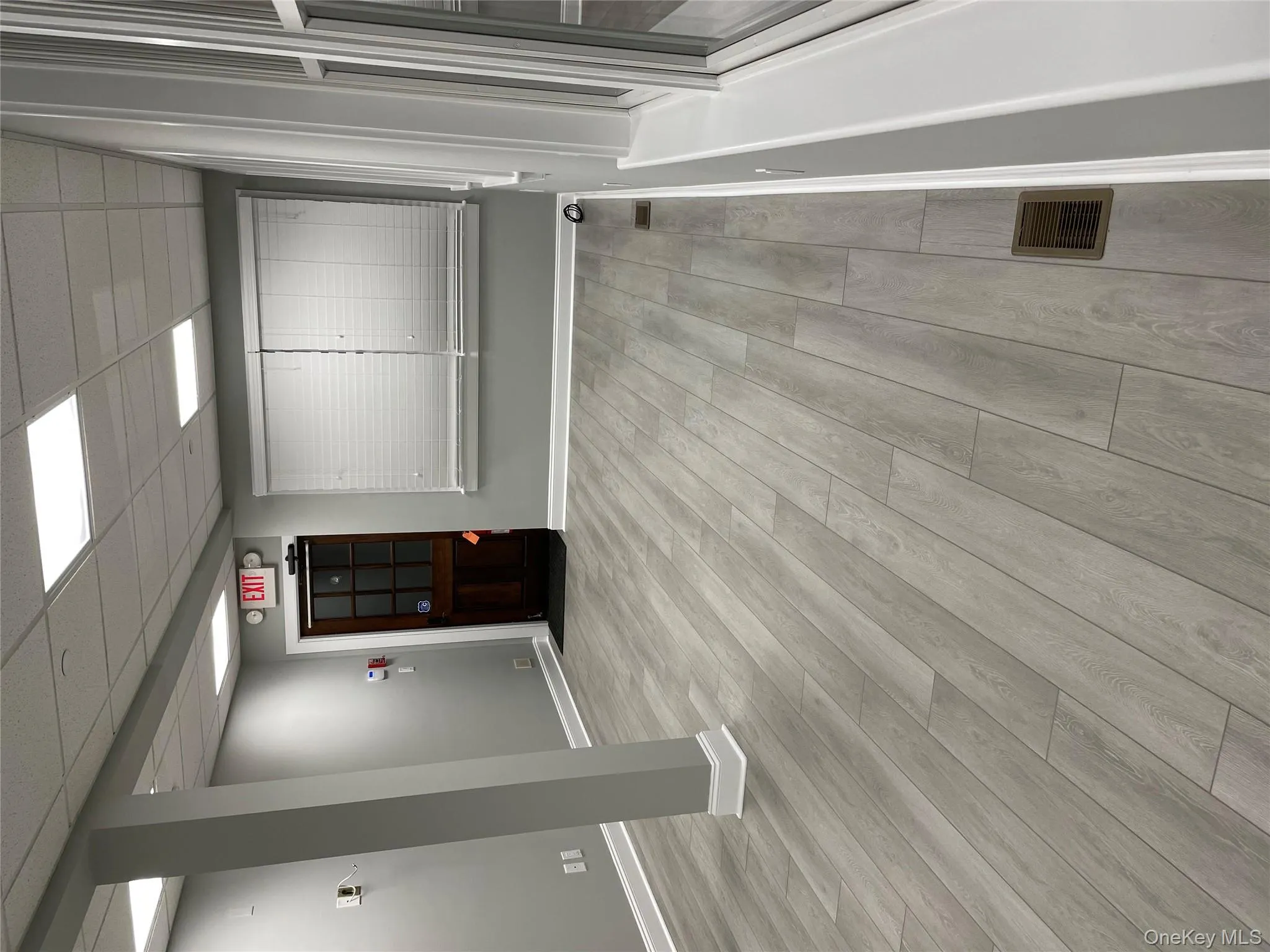 Empty room featuring light wood finished floors and a paneled ceiling Empty room featuring light wood finished floors and a paneled ceiling