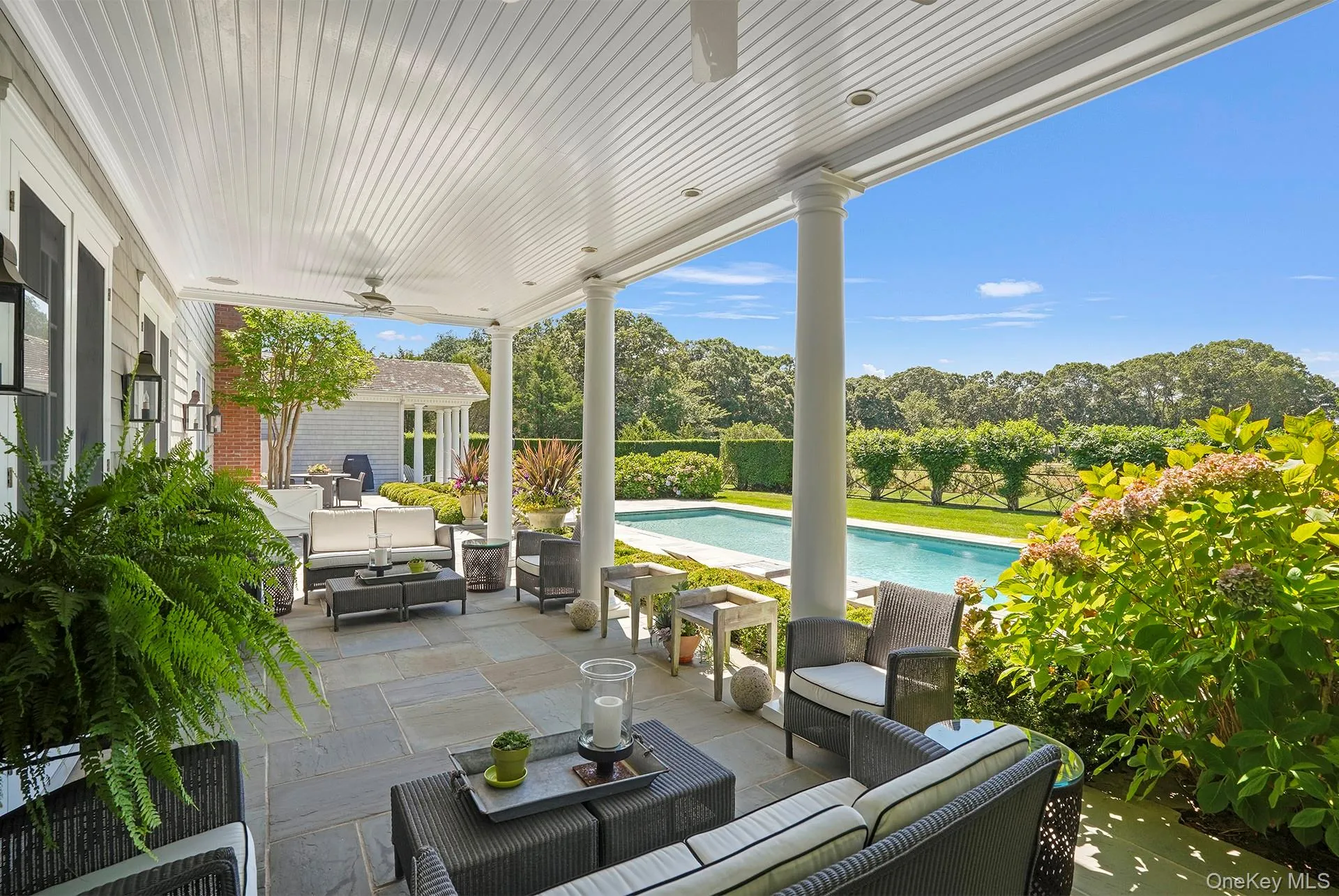View of patio featuring outdoor lounge area, a ceiling fan, and view of scattered trees View of patio featuring outdoor lounge area, a ceiling fan, and view of scattered trees