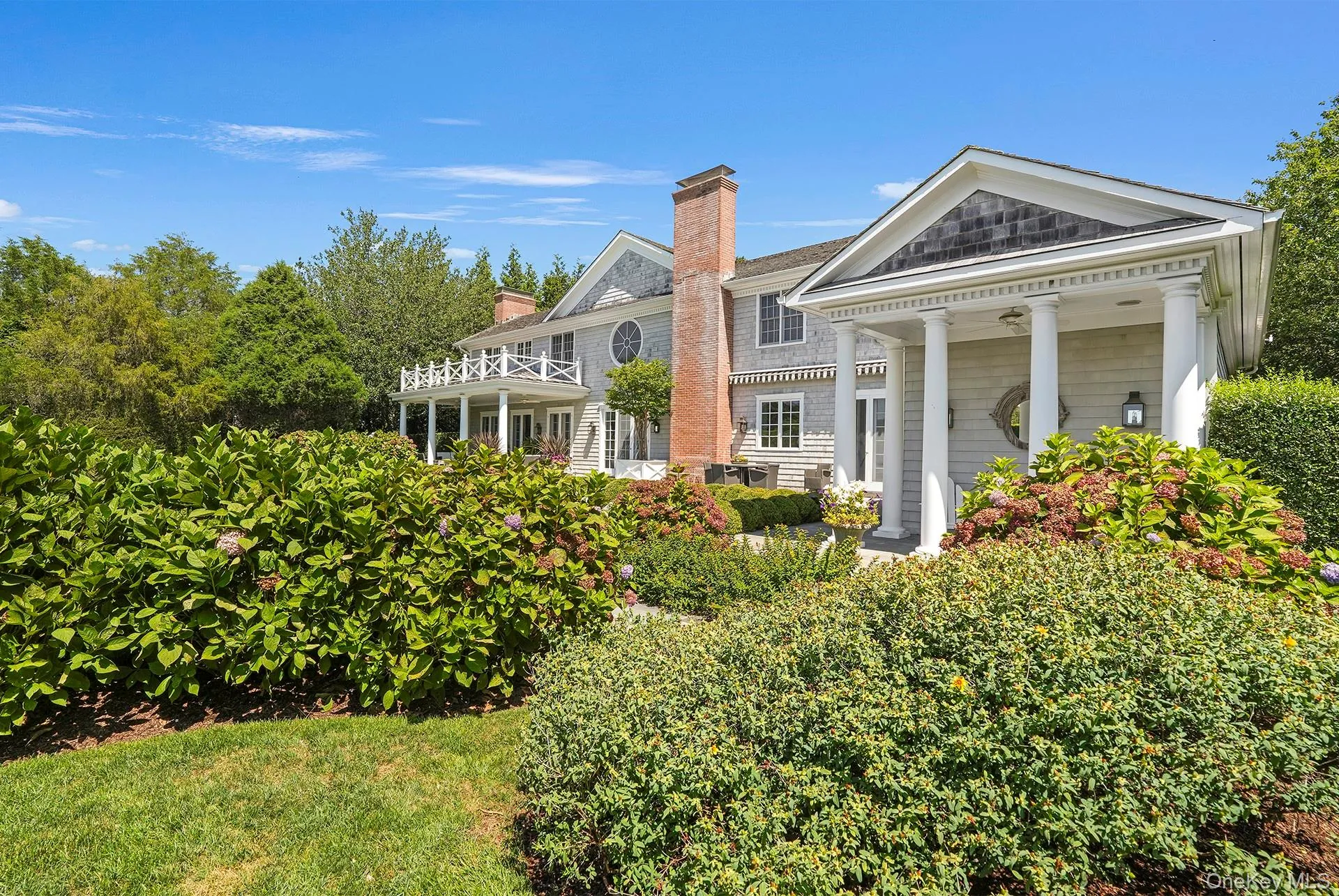 Back of house with a chimney and covered porch Back of house with a chimney and covered porch
