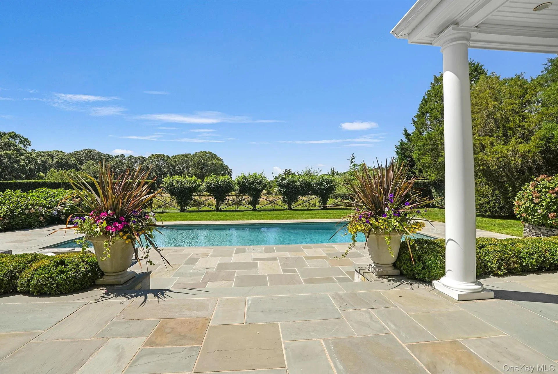 View of swimming pool featuring a patio area and a yard View of swimming pool featuring a patio area and a yard