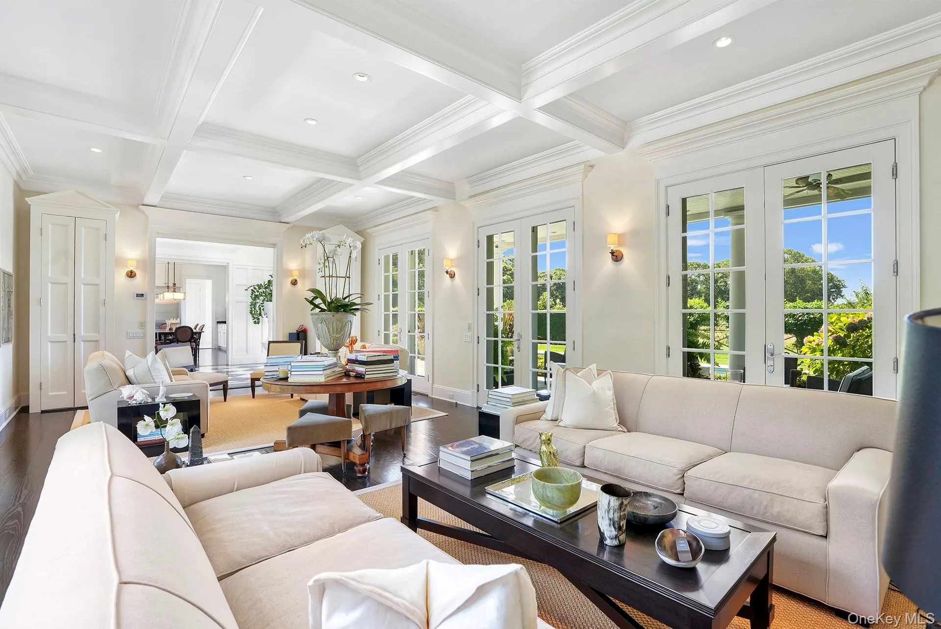 Living area featuring beamed ceiling, wood finished floors, coffered ceiling, french doors, and recessed lighting Living area featuring beamed ceiling, wood finished floors, coffered ceiling, french doors, and recessed lighting