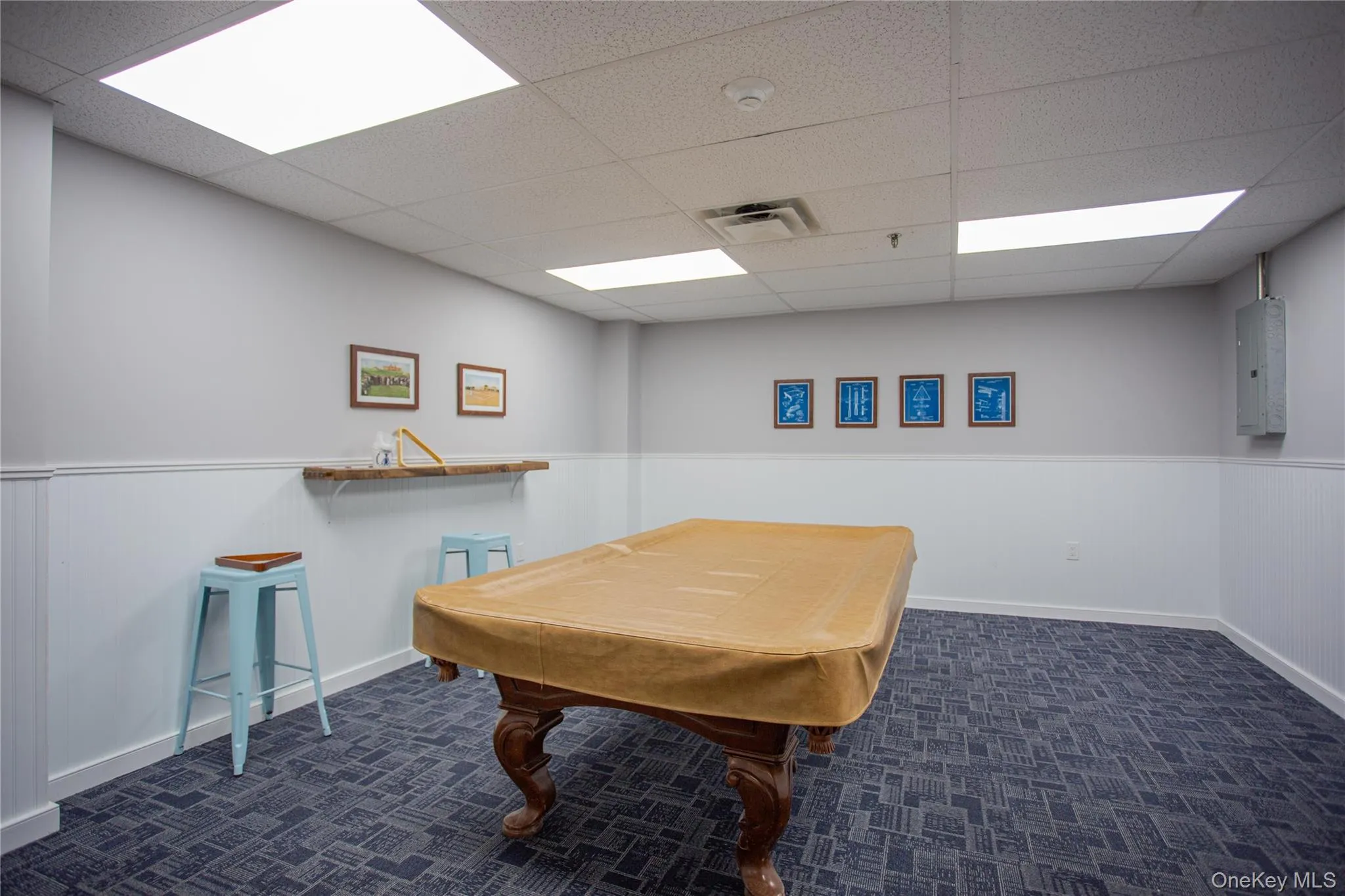 Game room with wainscoting, billiards table, a drop ceiling, and electric panel Game room with wainscoting, billiards table, a drop ceiling, and electric panel
