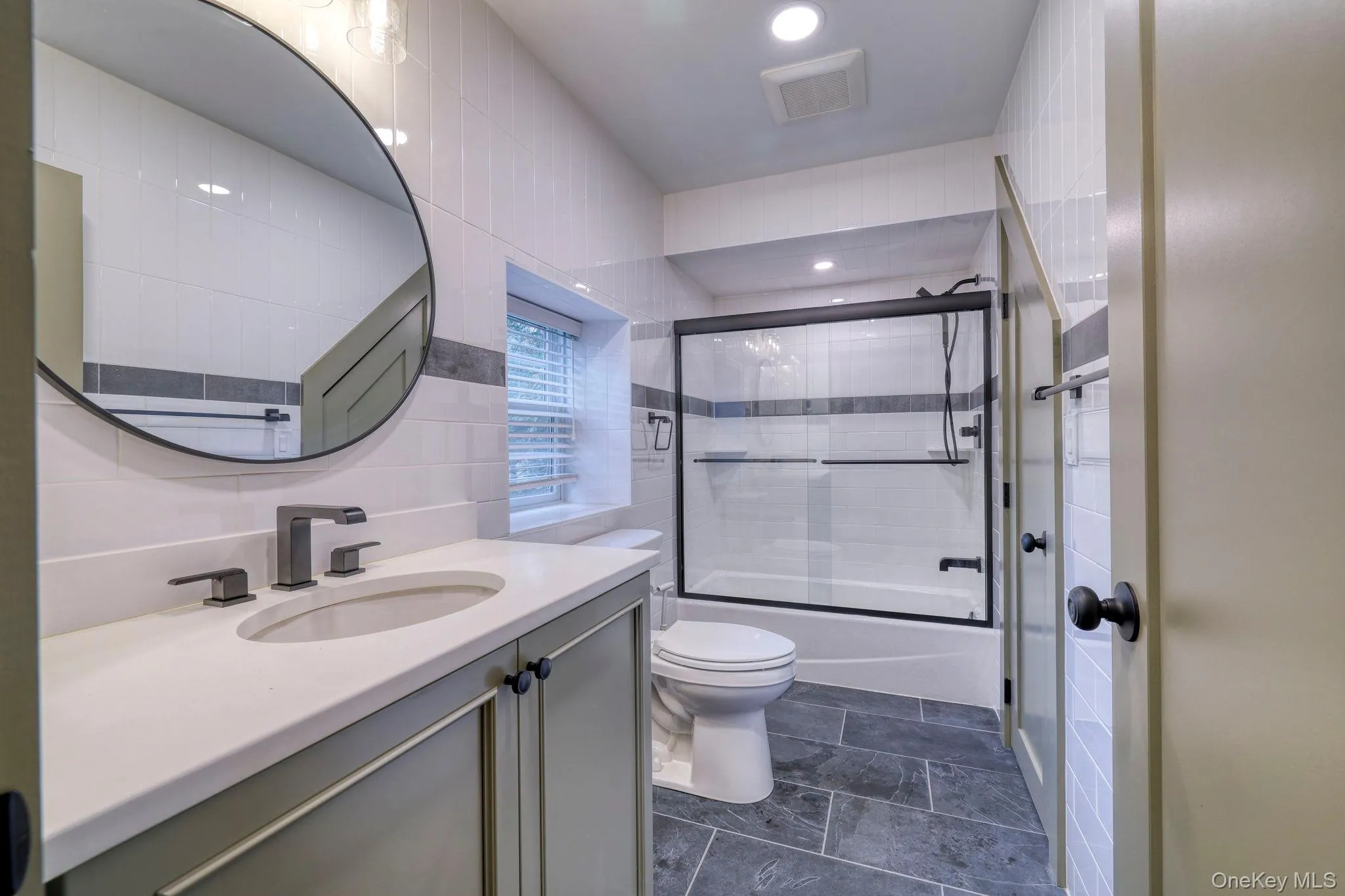 Bathroom with vanity and shower / bath combination with glass door Bathroom with vanity and shower / bath combination with glass door