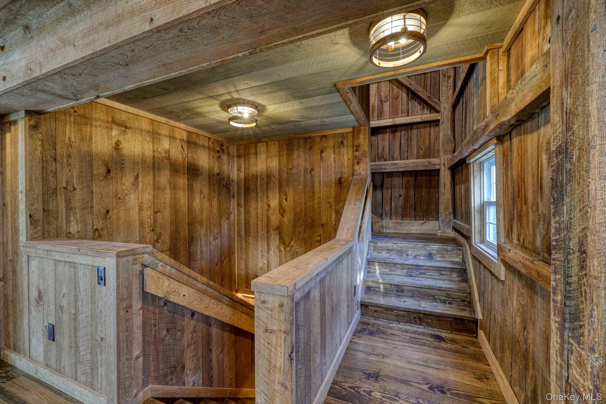 Stairway featuring a sauna, hardwood / wood-style floors, and wood walls Stairway featuring a sauna, hardwood / wood-style floors, and wood walls
