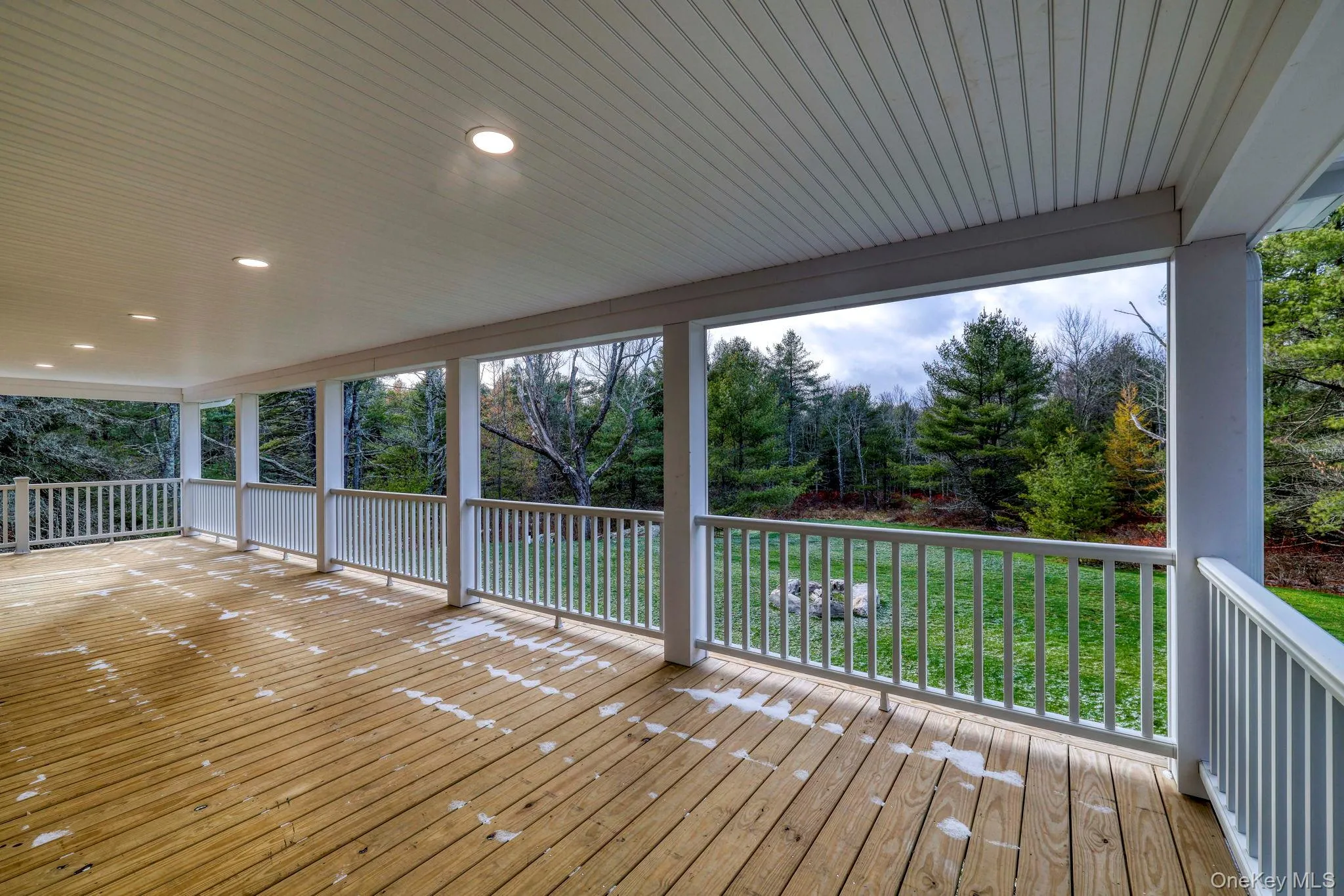 Wooden deck with view of scattered trees Wooden deck with view of scattered trees