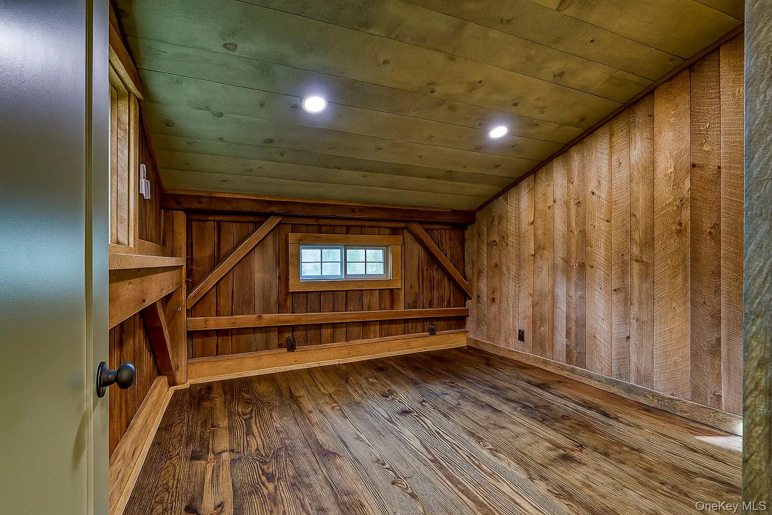 Bonus room with dark wood finished floors, recessed lighting, a sauna / steam room, wood walls, and vaulted ceiling Bonus room with dark wood finished floors, recessed lighting, a sauna / steam room, wood walls, and vaulted ceiling
