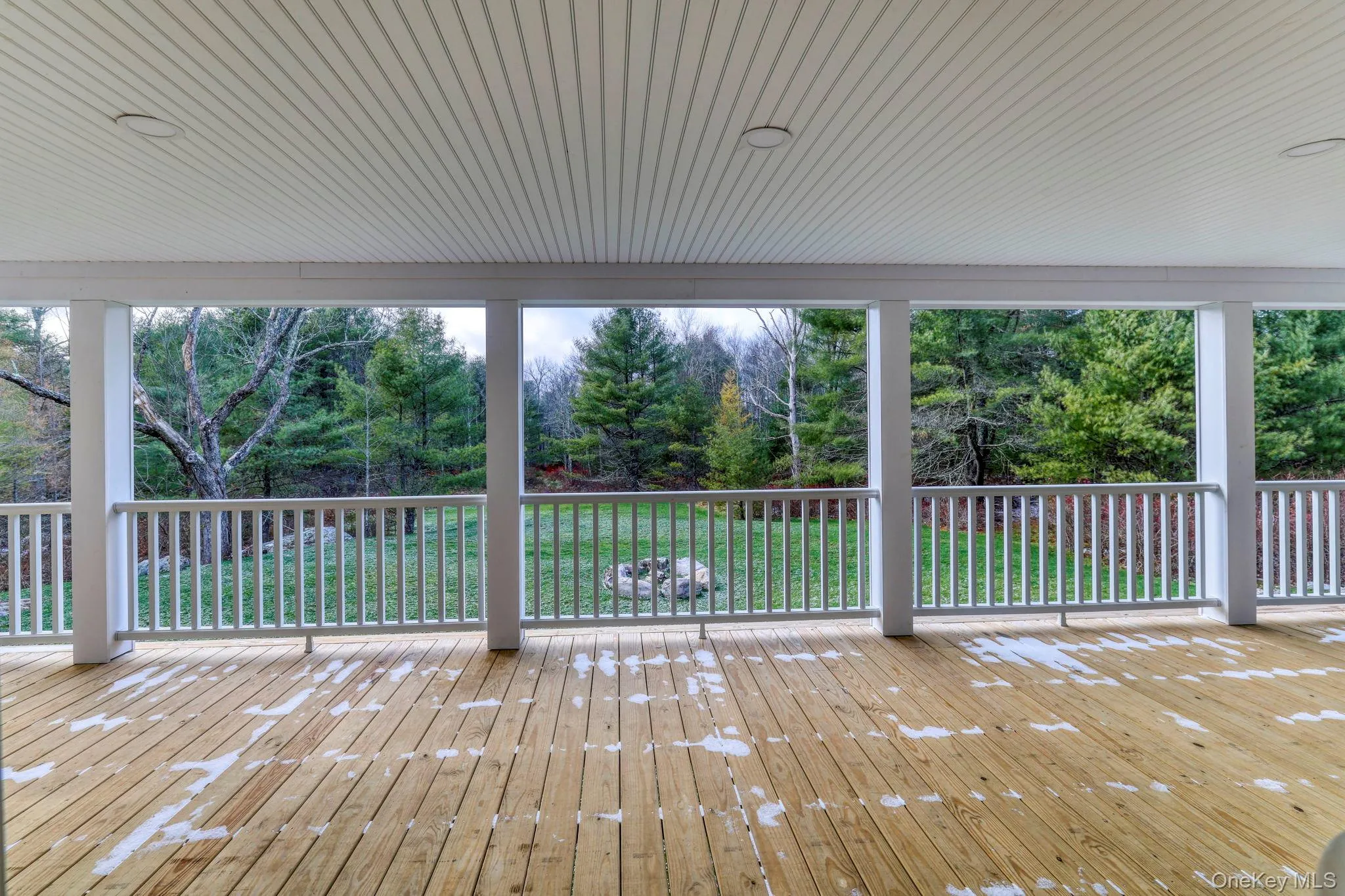 Wooden terrace featuring view of scattered trees Wooden terrace featuring view of scattered trees