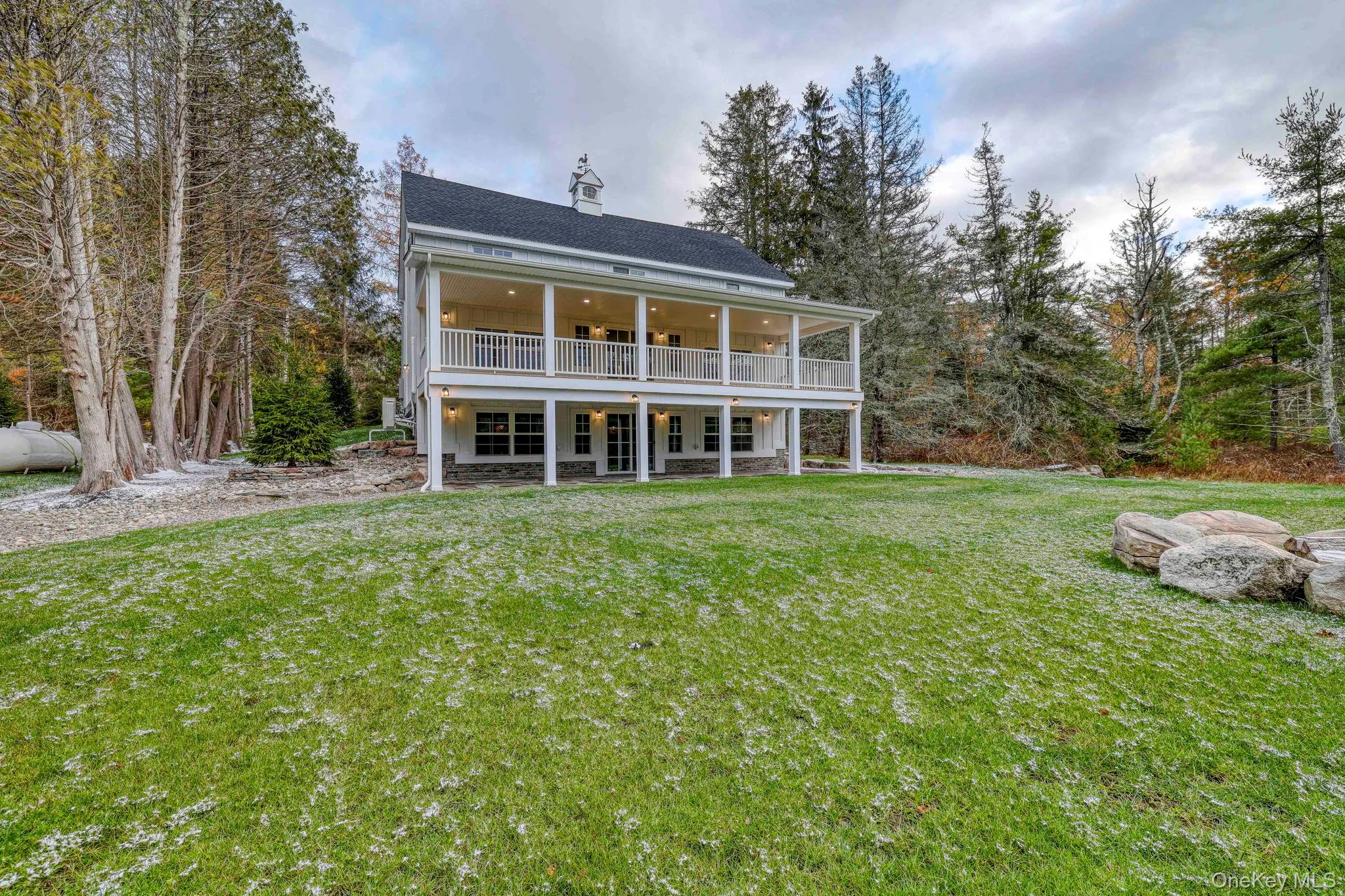 Back of property with a lawn, a chimney, roof with shingles, and a porch Back of property with a lawn, a chimney, roof with shingles, and a porch