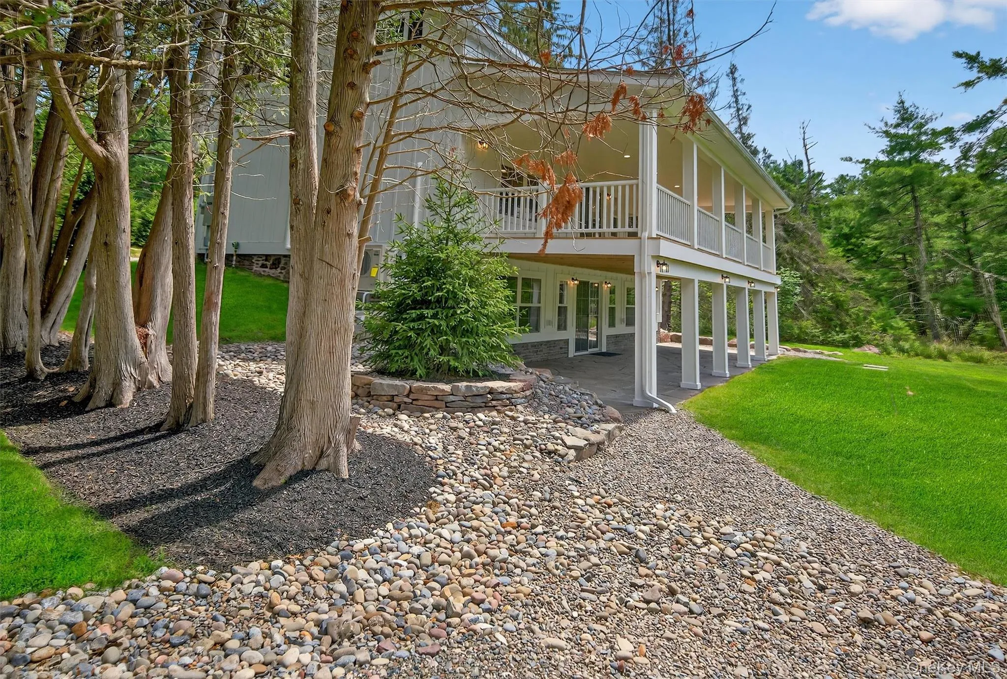 Rear view of house with a patio and a yard Rear view of house with a patio and a yard