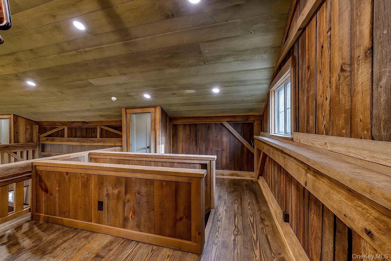 Bar area featuring wooden walls, a sauna, recessed lighting, dark wood-style floors, and brown cabinets Bar area featuring wooden walls, a sauna, recessed lighting, dark wood-style floors, and brown cabinets