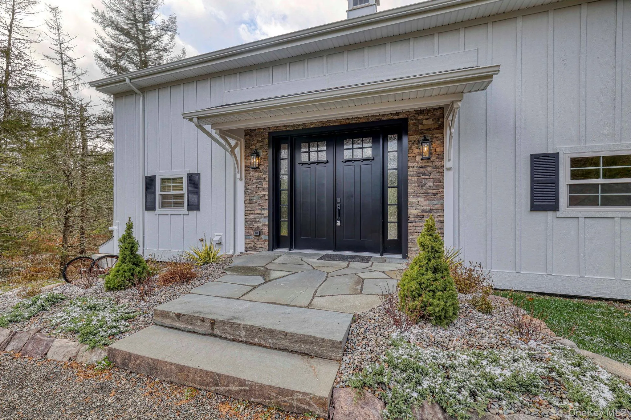 Doorway to property with board and batten siding Doorway to property with board and batten siding
