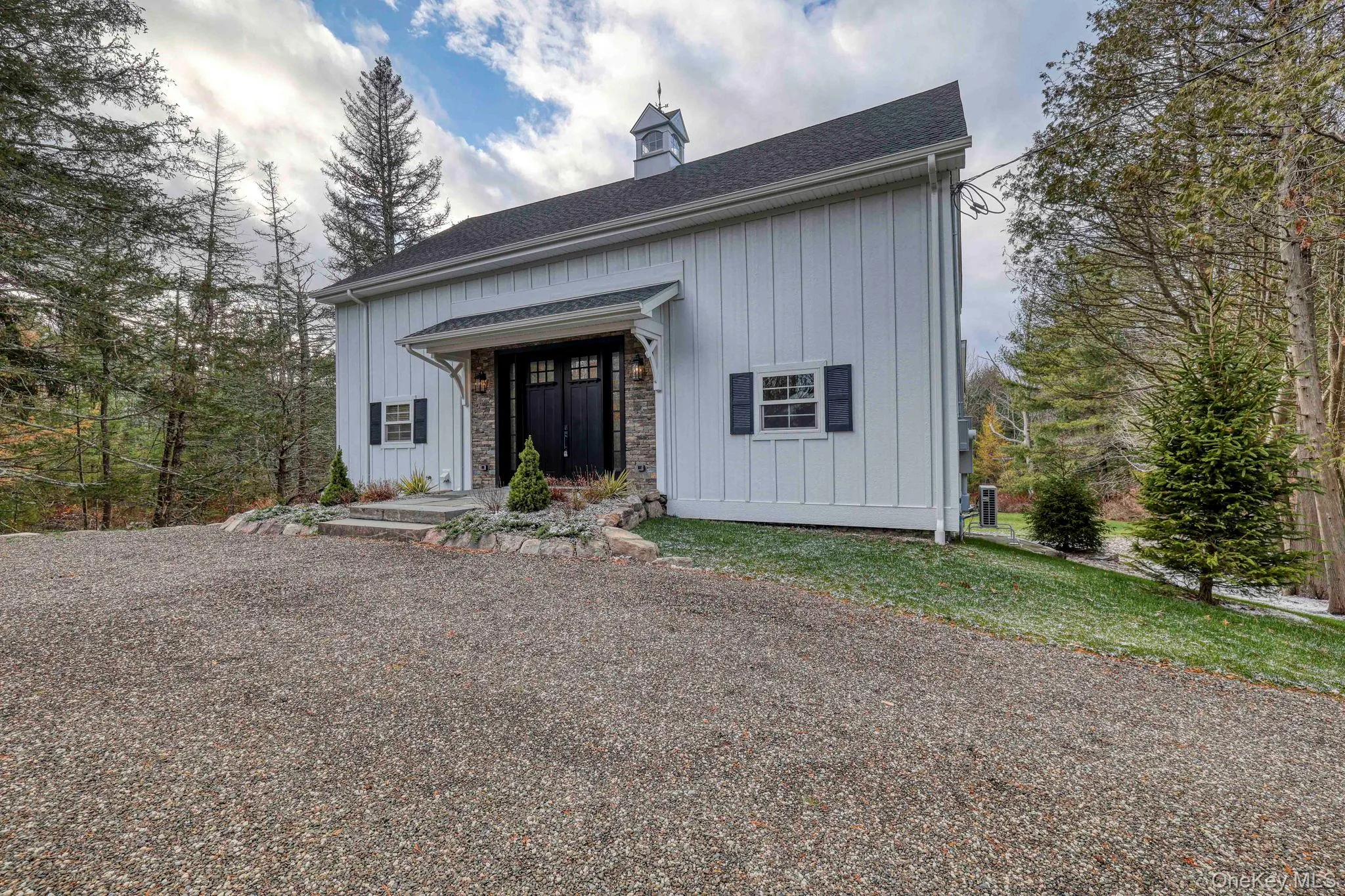 View of front of property featuring board and batten siding, stone siding, and a shingled roof View of front of property featuring board and batten siding, stone siding, and a shingled roof