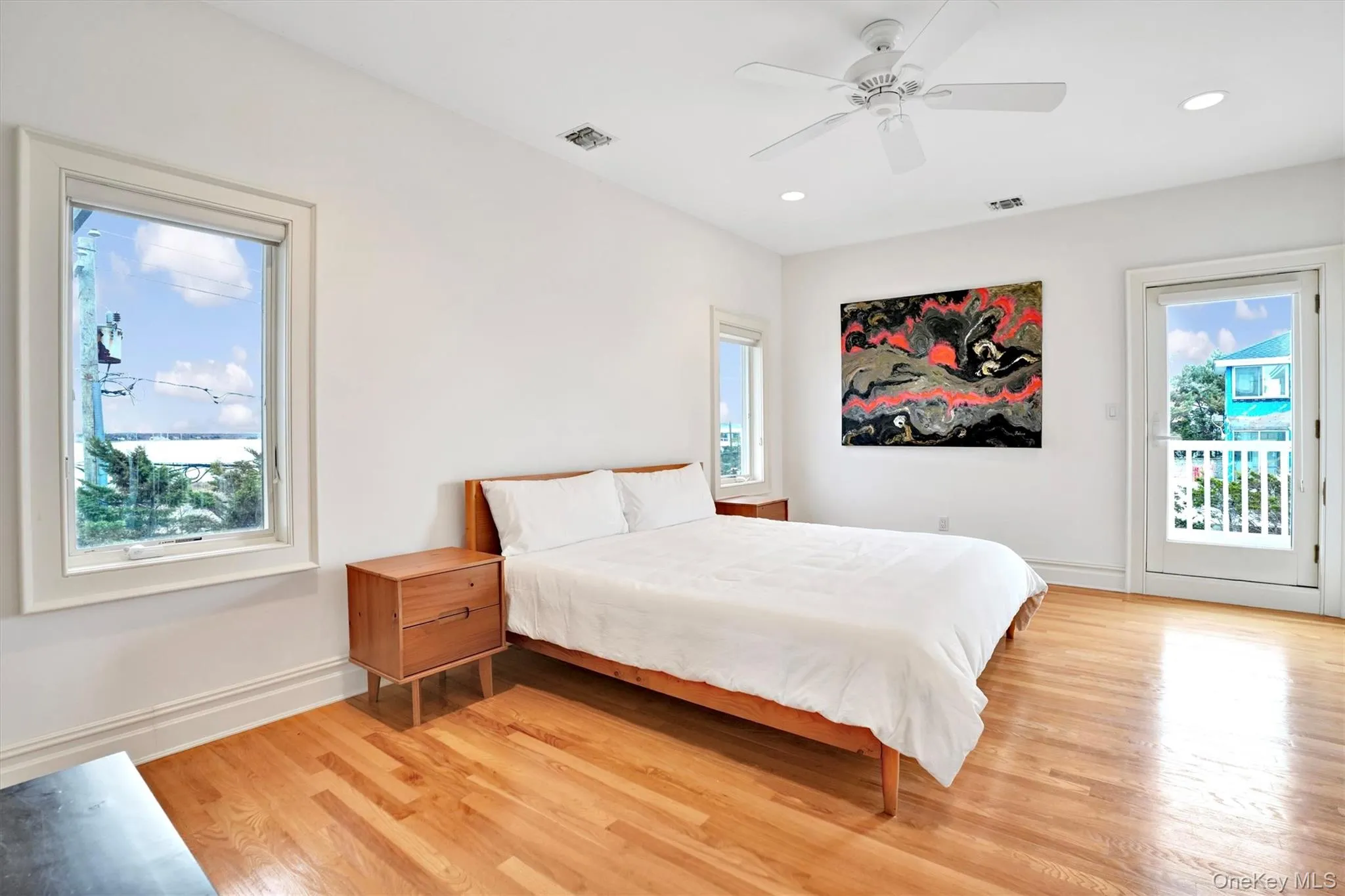 4th Bedroom with Bay and door to sitting deck for Ocean & Bay views, featuring access to outside, light wood-type flooring, a ceiling fan, and recessed lighting