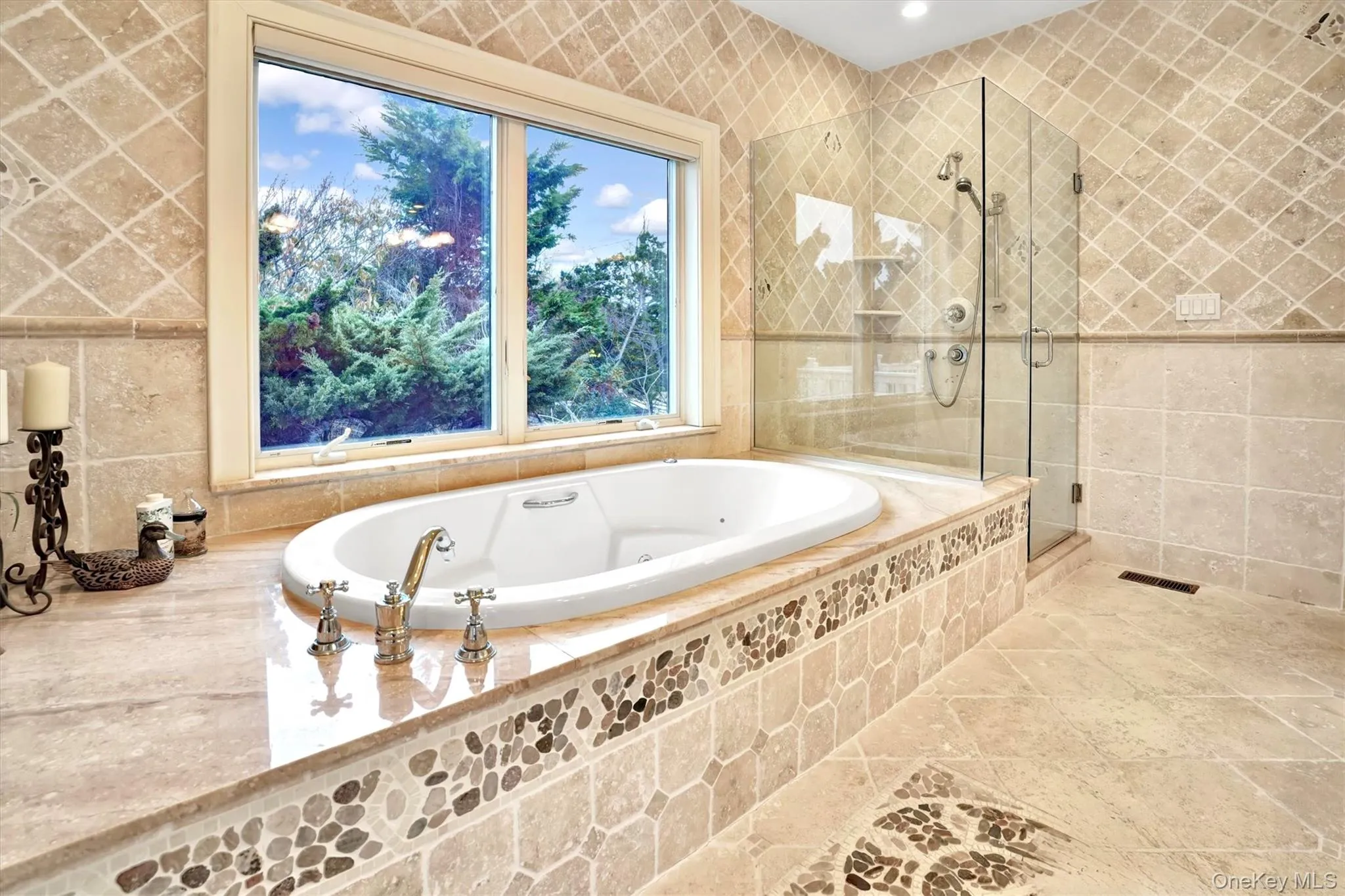 First Floor en-suite Deluxe Primary Bathroom for first floor Primary with tile walls, a jetted tub, a stall shower, and tile patterned flooring