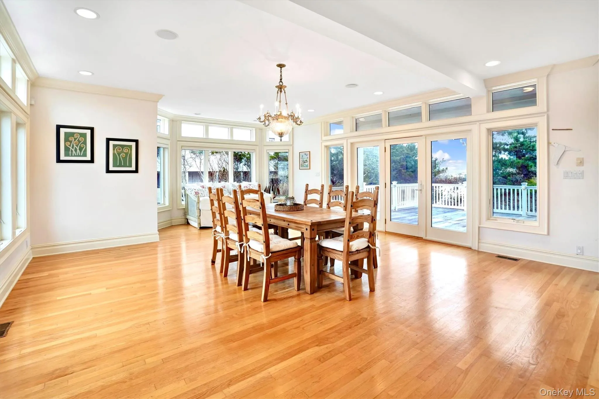 Huge Dining area with healthy amount of natural light, light wood-type flooring, a chandelier, and recessed lighting. Doors out to very large deck.