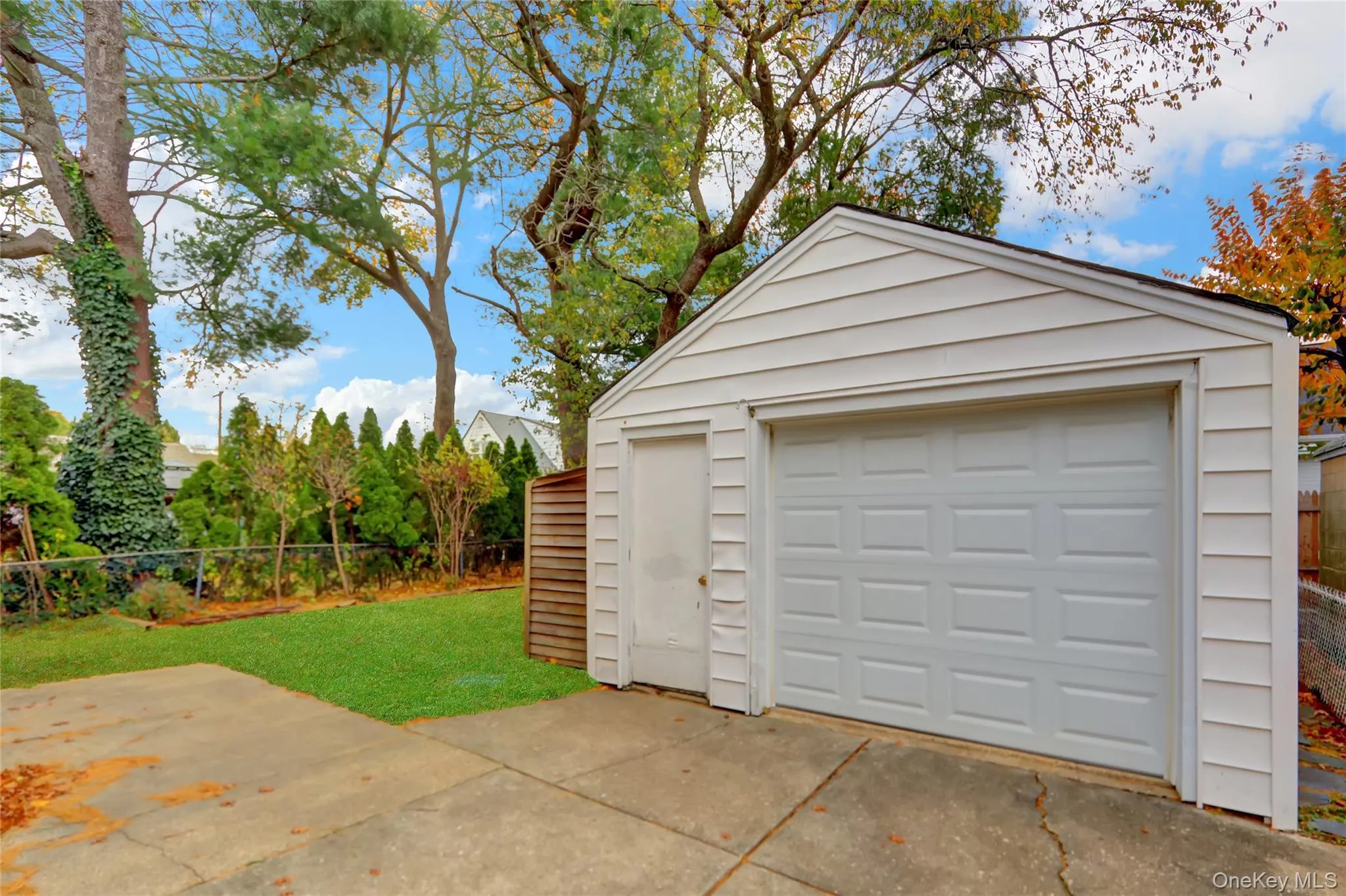 Detached garage featuring concrete driveway Detached garage featuring concrete driveway