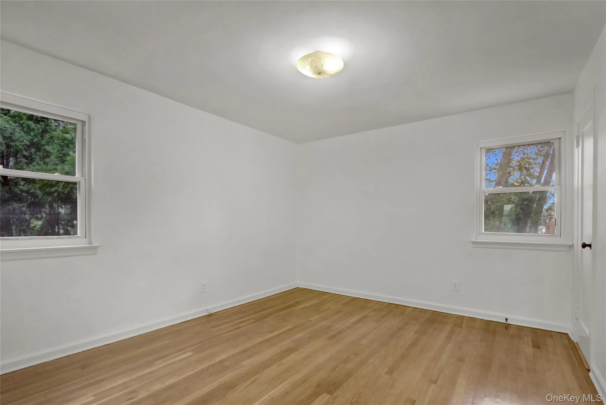 1st floor bedroom featuring light wood-style floors 1st floor bedroom featuring light wood-style floors