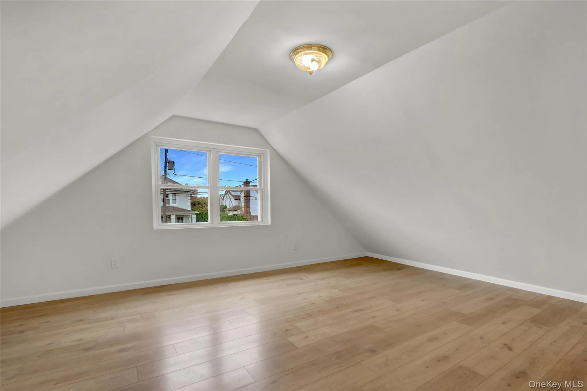 Additional living space featuring light wood finished floors and lofted ceiling Additional living space featuring light wood finished floors and lofted ceiling