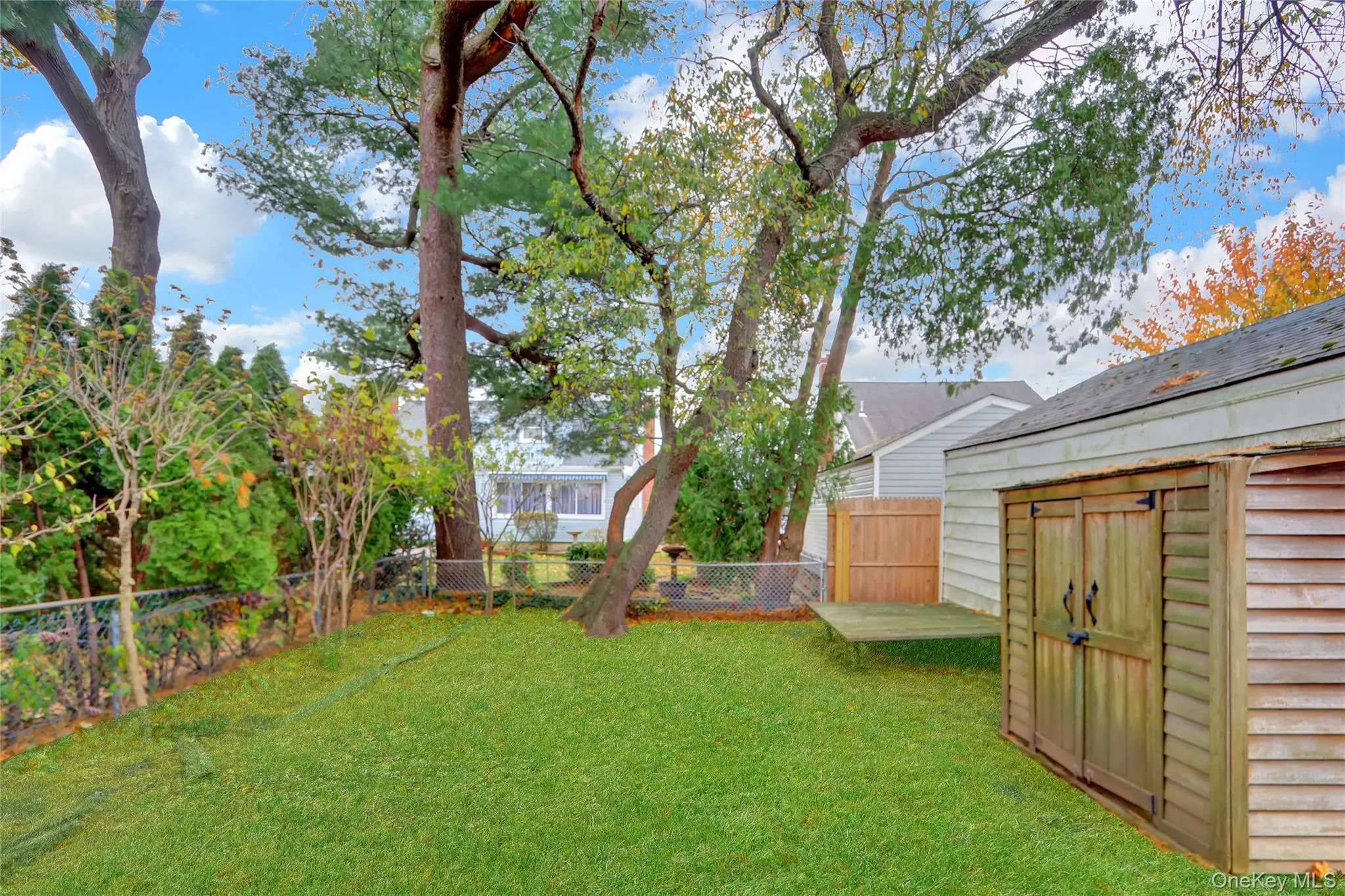 Fenced backyard with a storage shed Fenced backyard with a storage shed