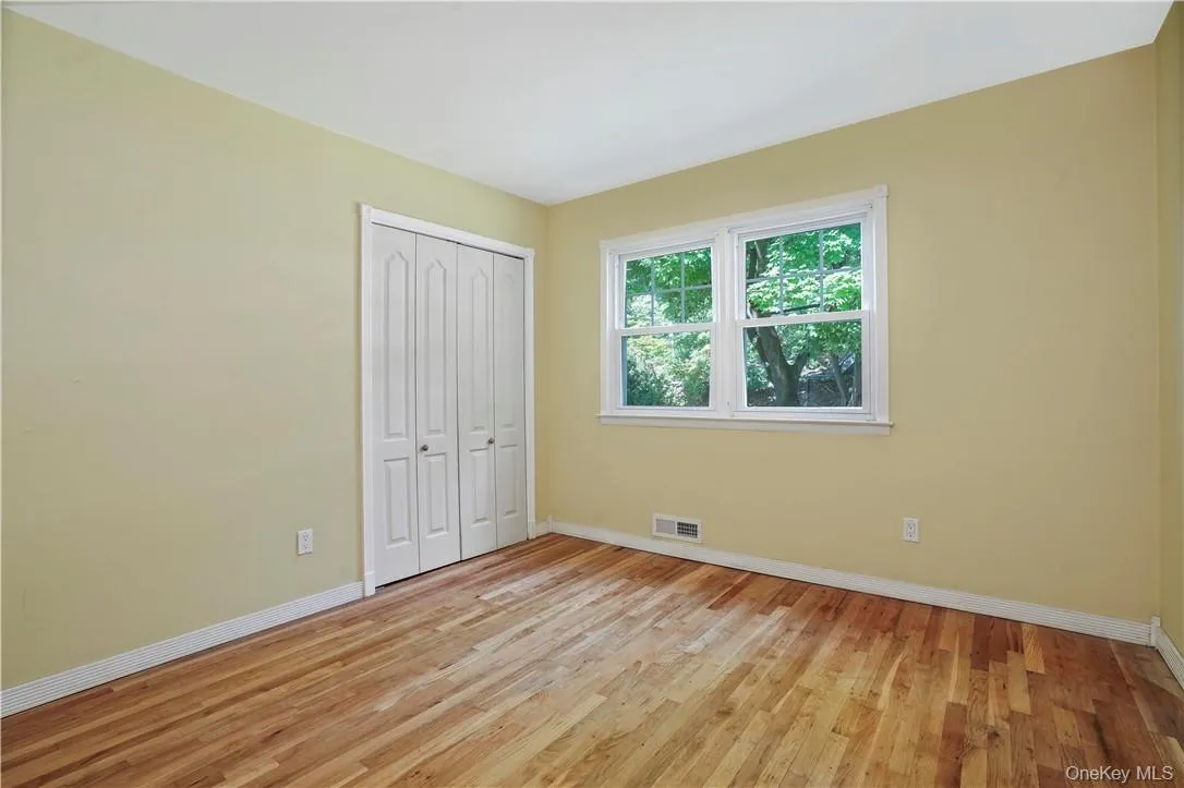Unfurnished bedroom featuring a closet and light hardwood / wood-style floors Unfurnished bedroom featuring a closet and light hardwood / wood-style floors