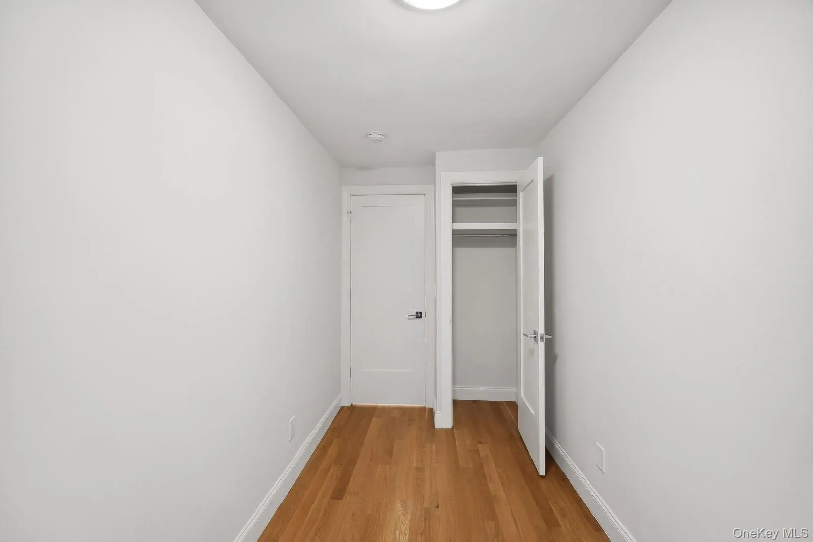 Hall with light wood-style floors and baseboards Hall with light wood-style floors and baseboards