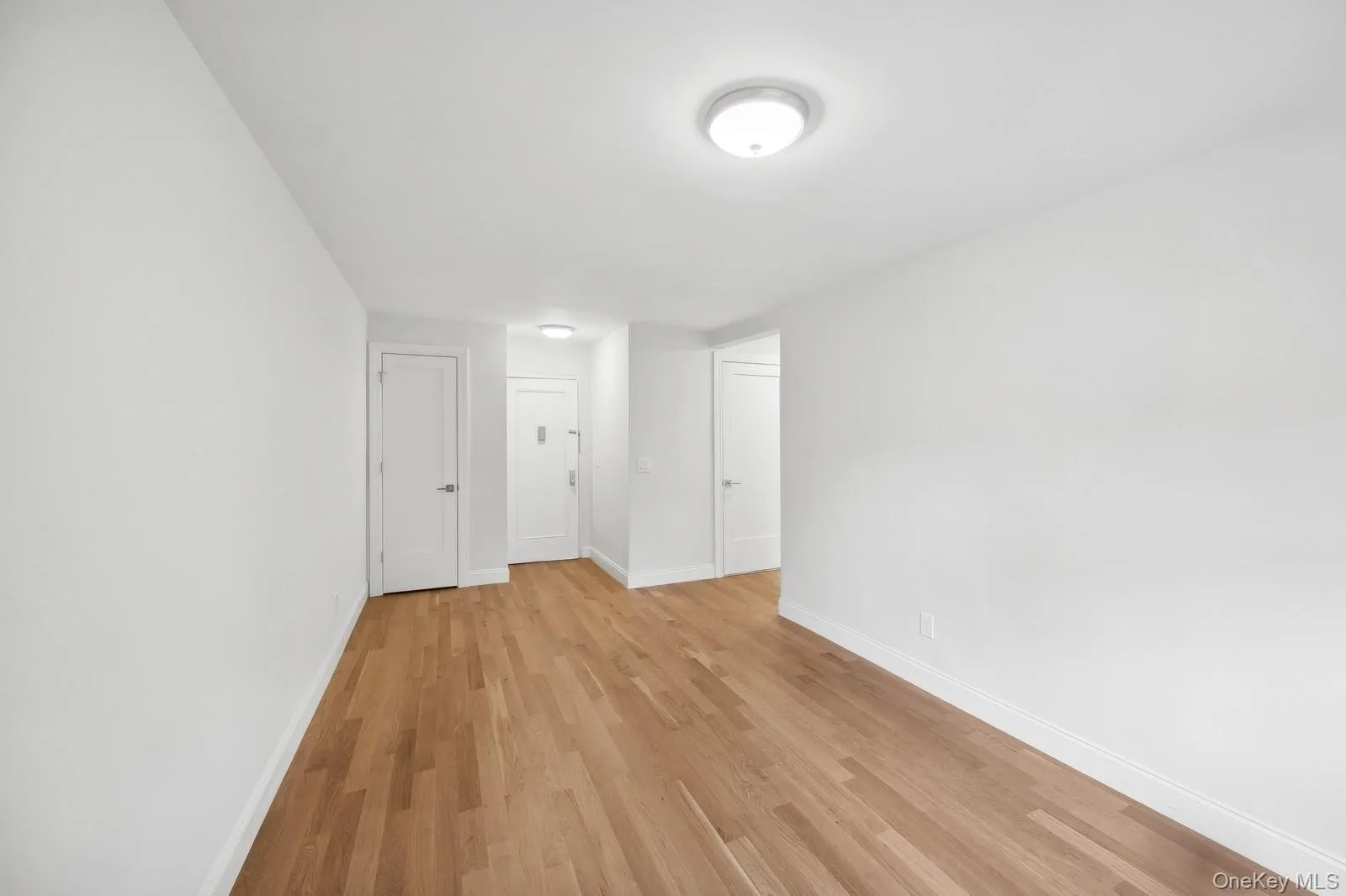 Unfurnished room with baseboards and light wood-style flooring Unfurnished room with baseboards and light wood-style flooring